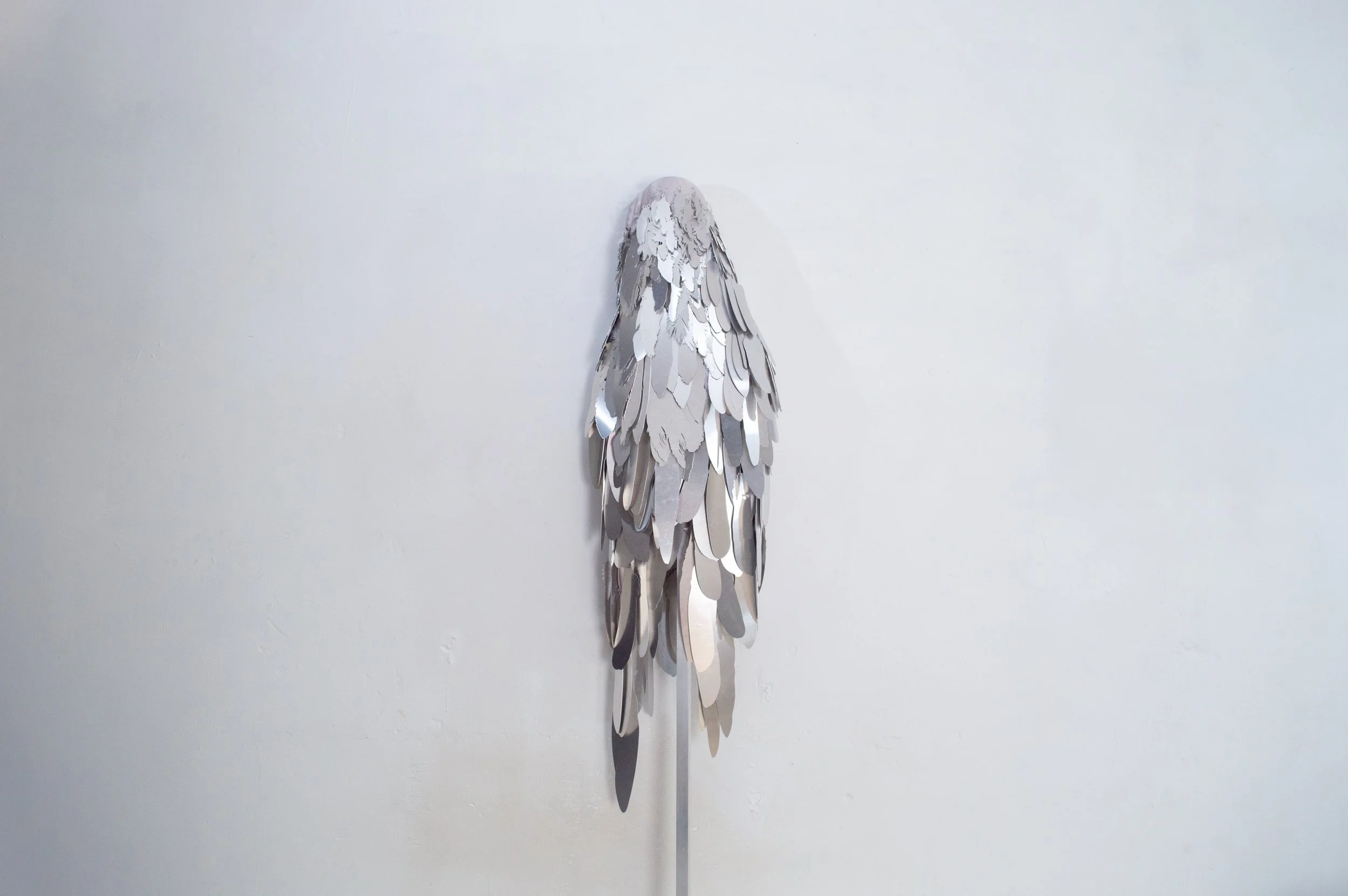 Severin Hallauer, Armour (Leftovers of Salvation), life-sized sculpture composed of aluminium feathers inspired by grey heron plumage. Contemporary sculpture exploring protection, migration, vulnerability, and the promise of escape.