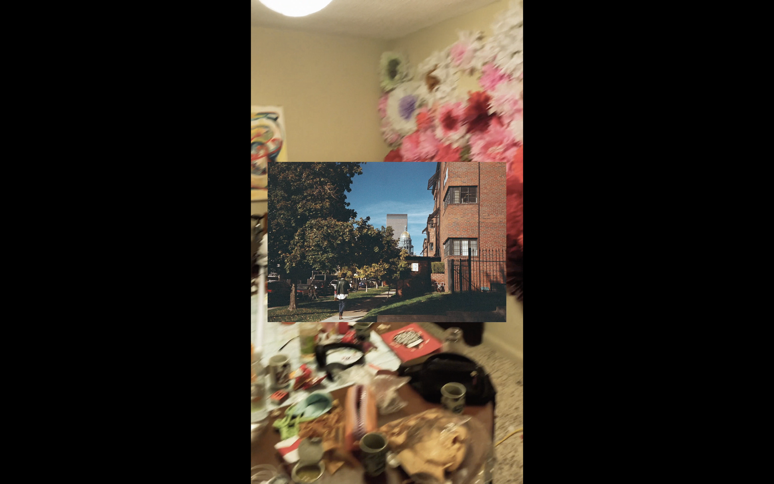 art video by swiss artist SEVERIN HALLAUER - consisting  of analog photographs. A collage of two photos: the top image shows a room with floral decorations and a table, the bottom image shows a cityscape with trees, buildings.