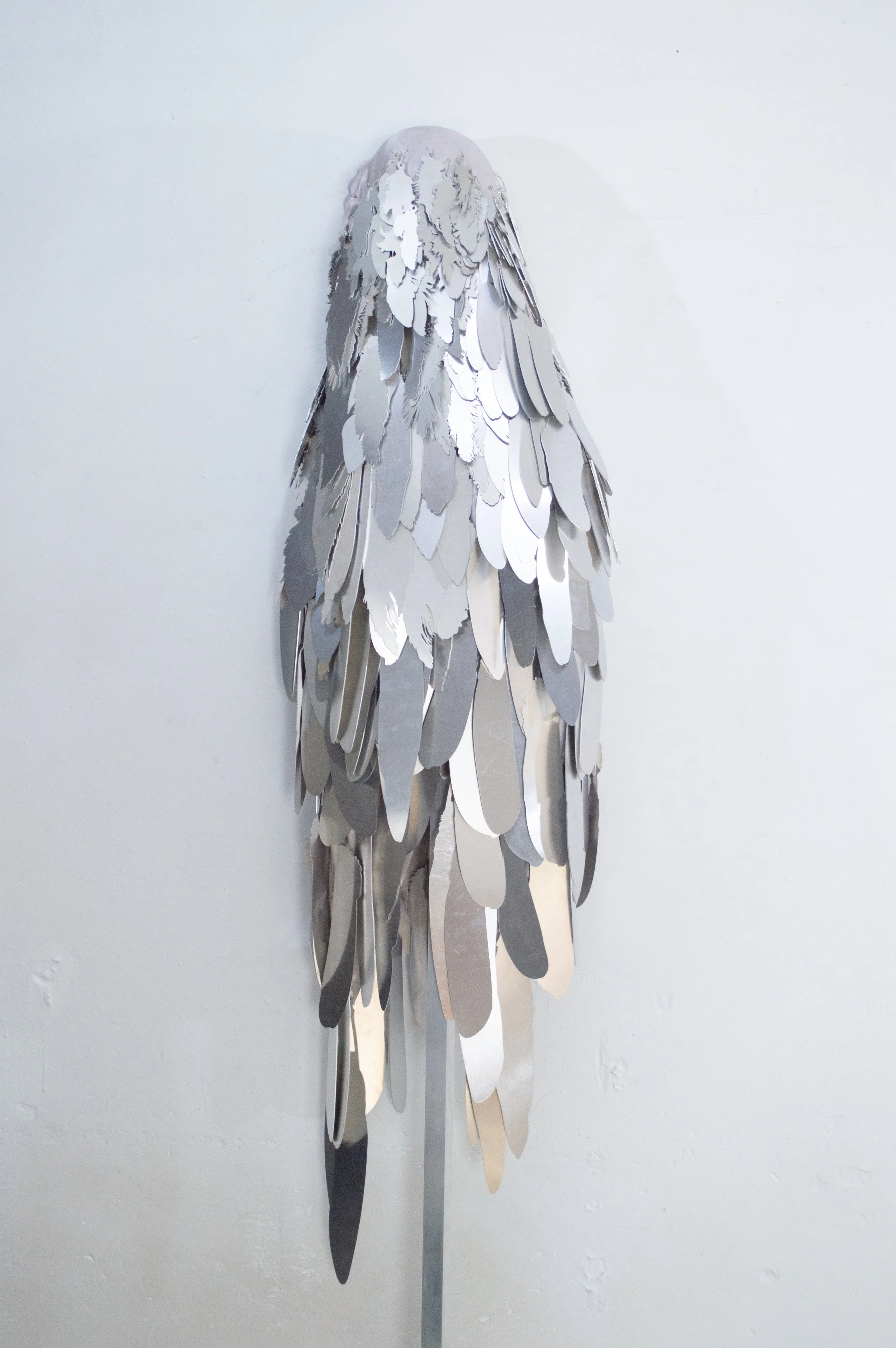 Severin Hallauer, Armour (Leftovers of Salvation), life-sized sculpture composed of aluminium feathers inspired by grey heron plumage. Contemporary sculpture exploring protection, migration, vulnerability, and the promise of escape.