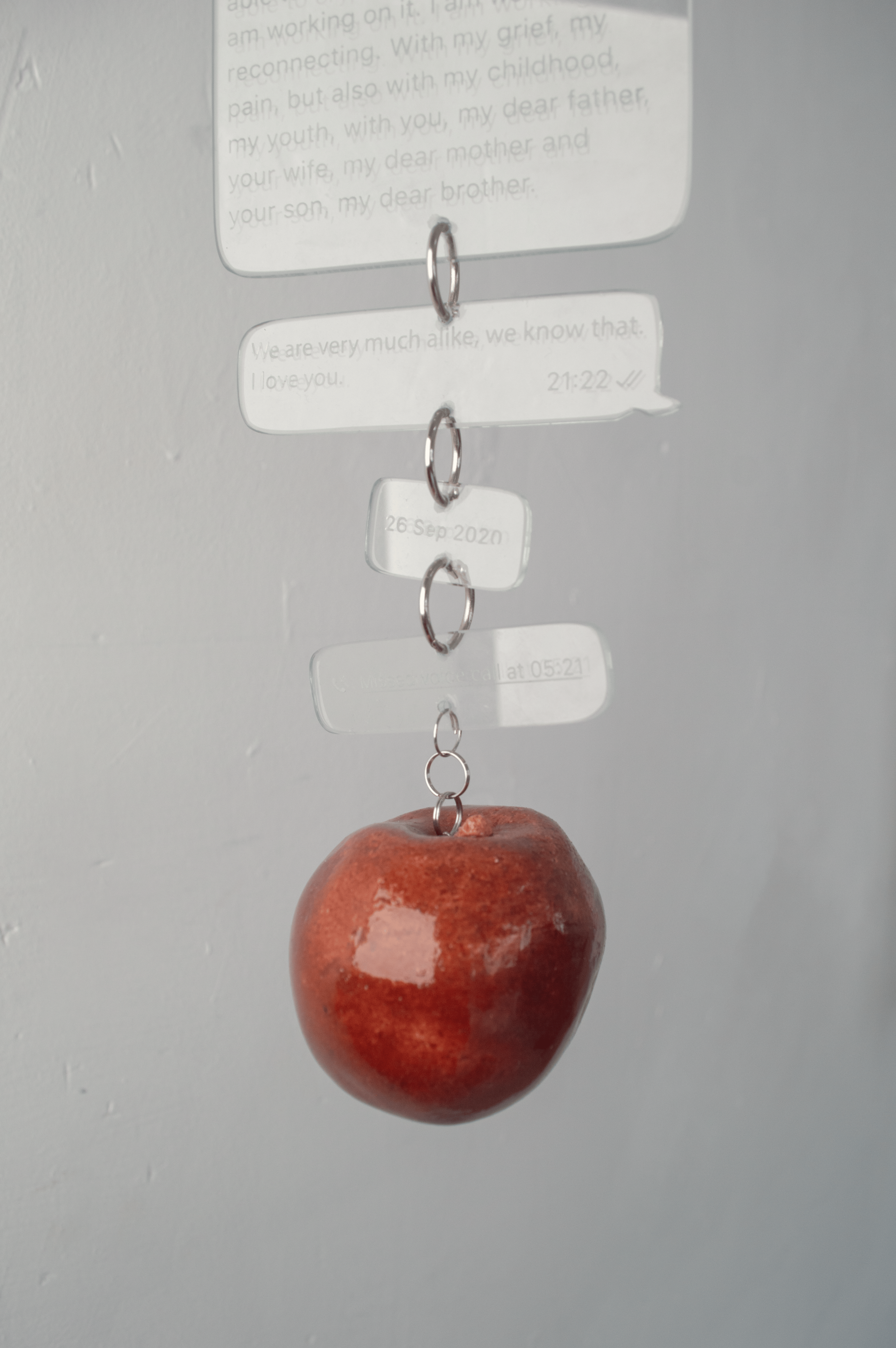 Repeat, 2026
Repeat is a wall-mounted sculpture by Severin Hallauer combining steel, engraved glass, and ceramic. Through a personal letter to the artist's father and the symbolism of an apple hanging from a branch, the work reflects on inherited tra