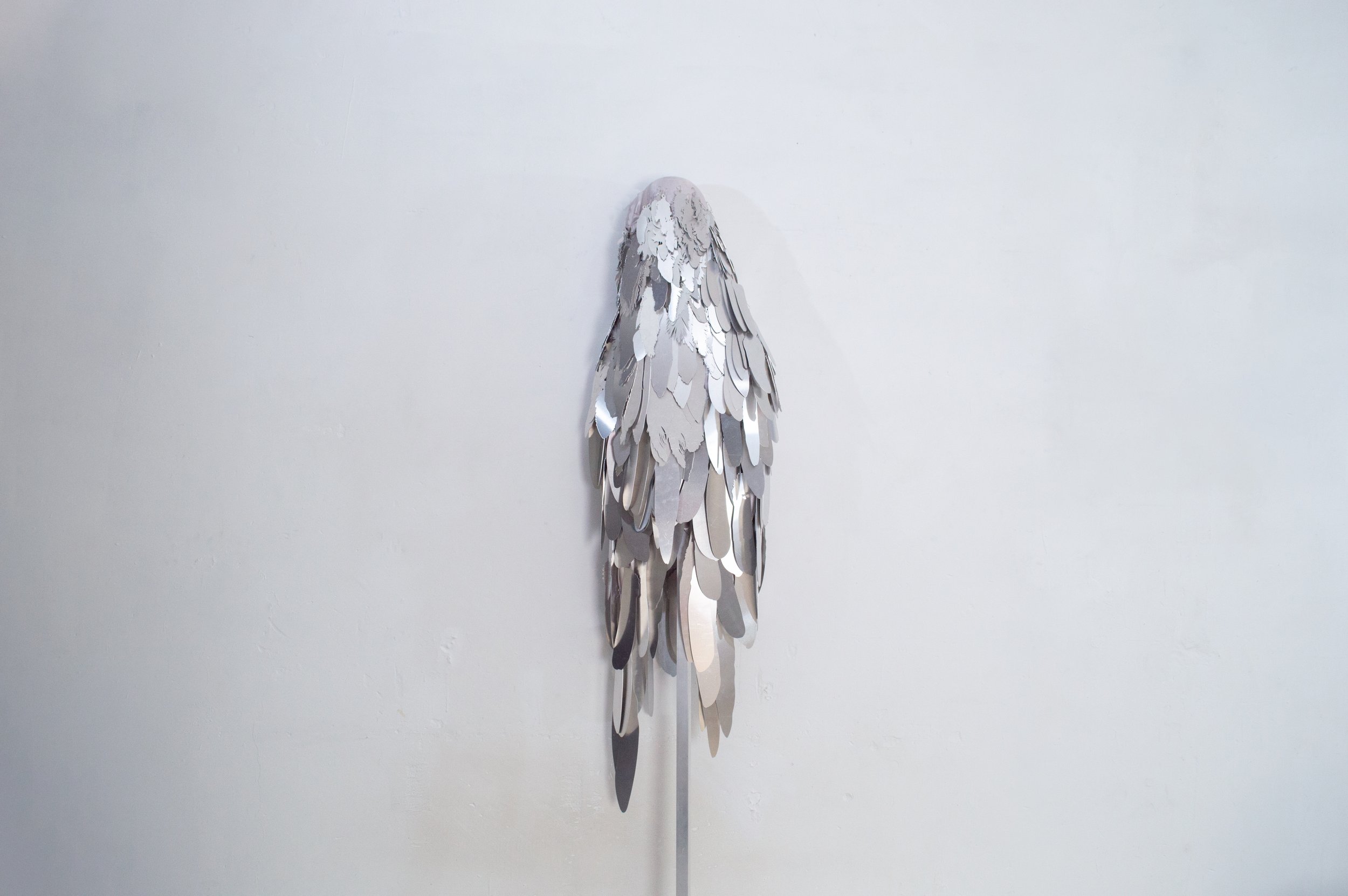Severin Hallauer, Armour (Leftovers of Salvation), life-sized sculpture composed of aluminium feathers inspired by grey heron plumage. Contemporary sculpture exploring protection, migration, vulnerability, and the promise of escape.