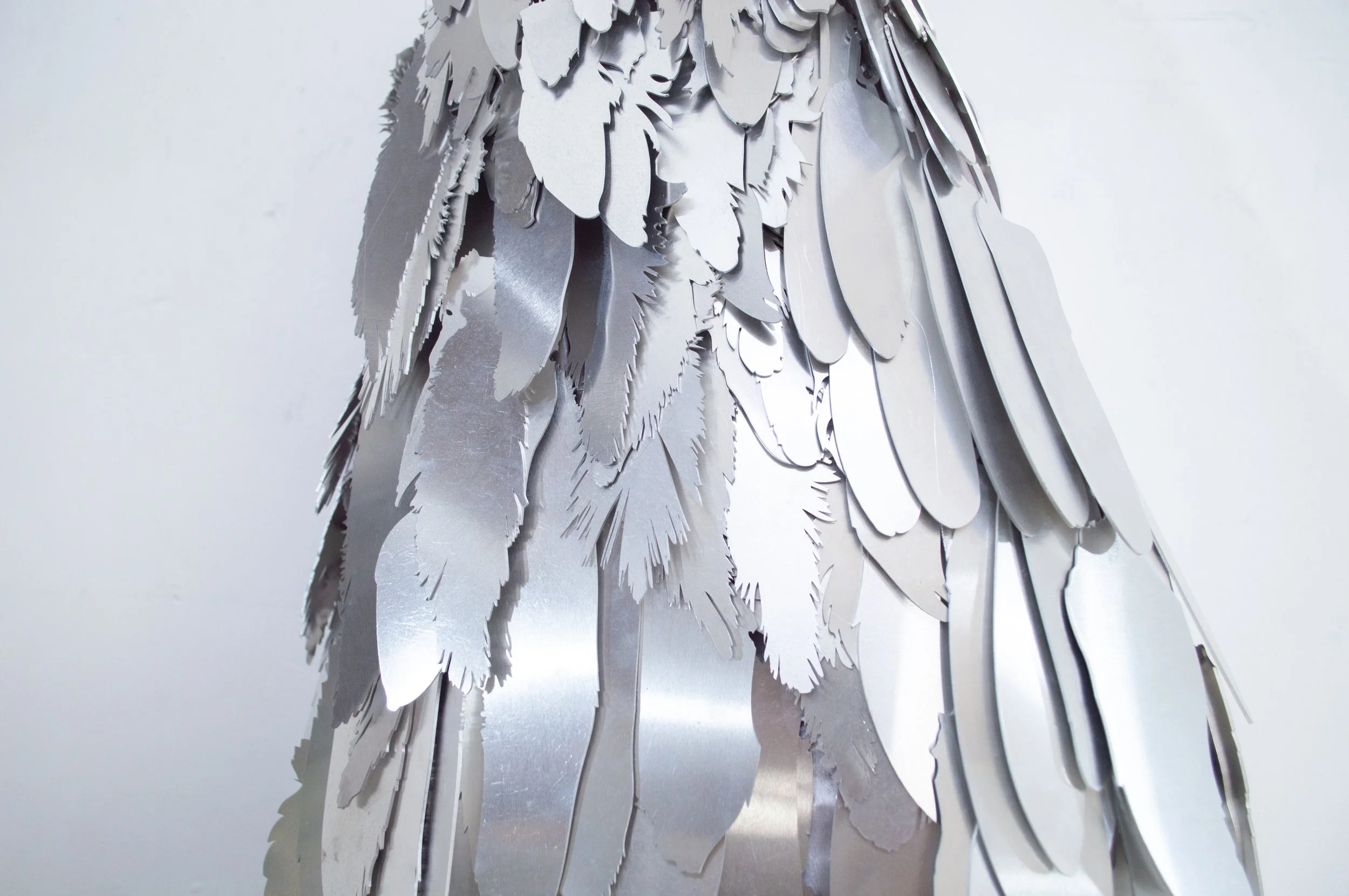 Severin Hallauer, Armour (Leftovers of Salvation), life-sized sculpture composed of aluminium feathers inspired by grey heron plumage. Contemporary sculpture exploring protection, migration, vulnerability, and the promise of escape.