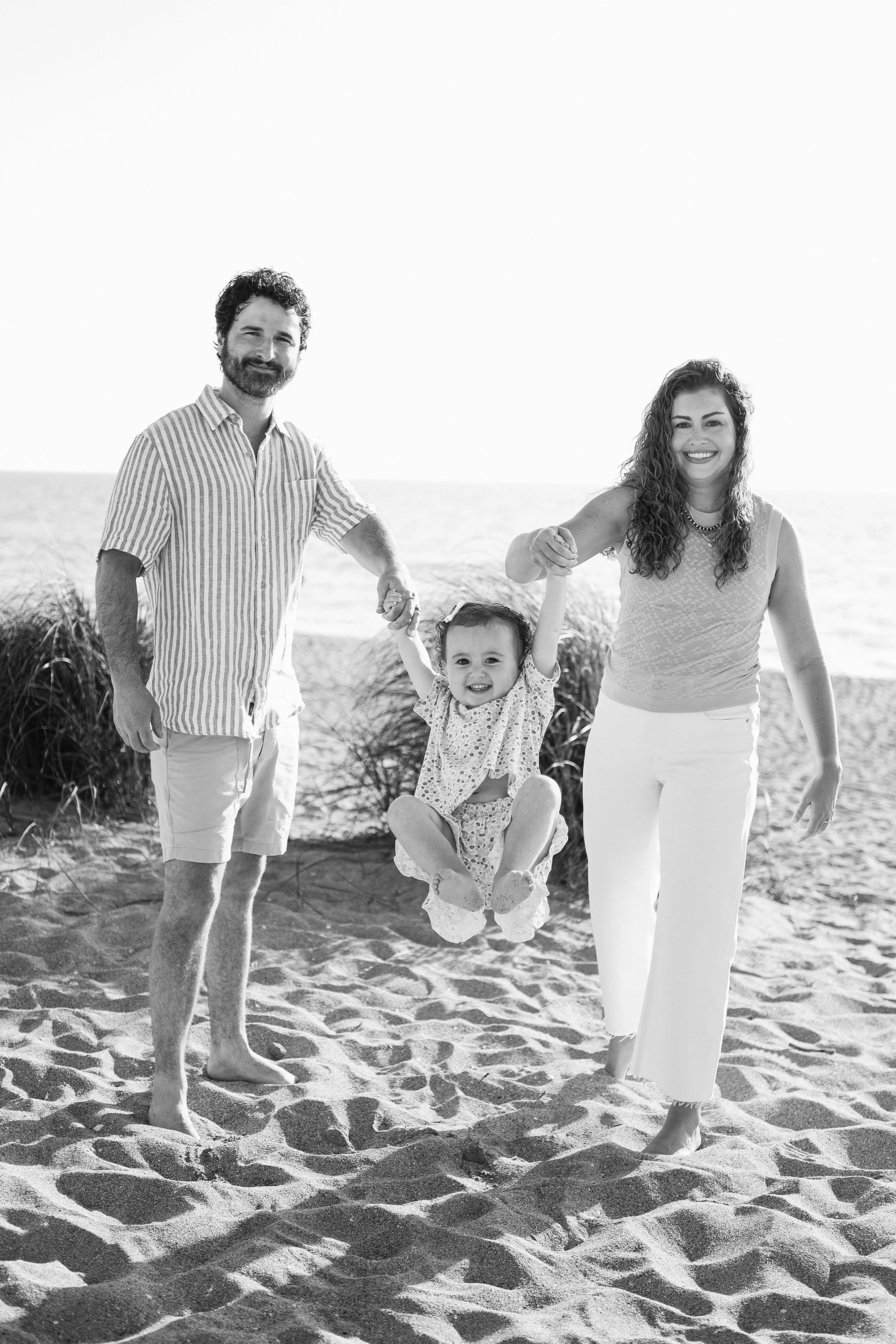 family-beach-photoshoot-venice-florida-swinging-black-and-white.jpg