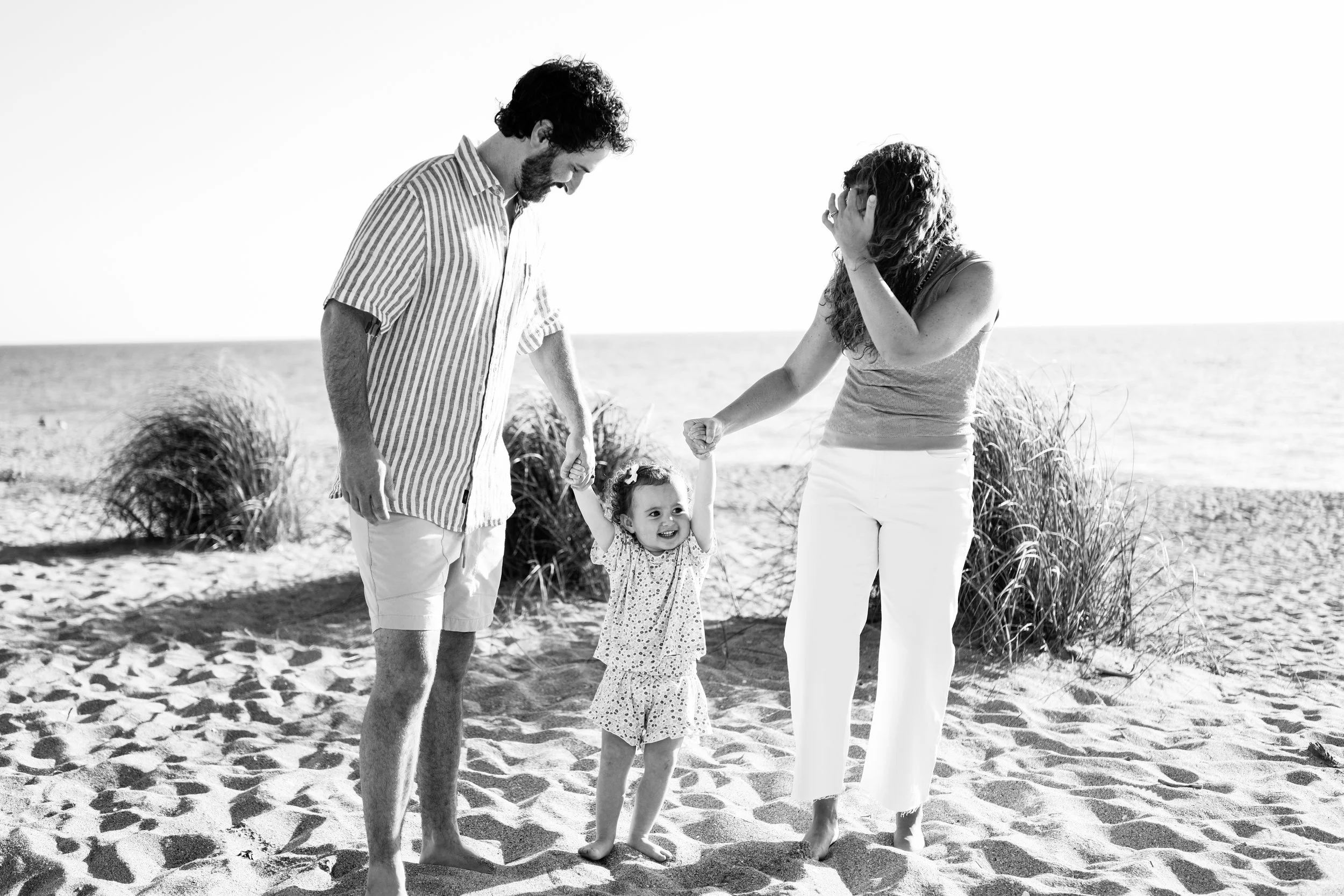family-beach-photoshoot-venice-florida-walking-swinging-toddler-black-and-white3.jpg