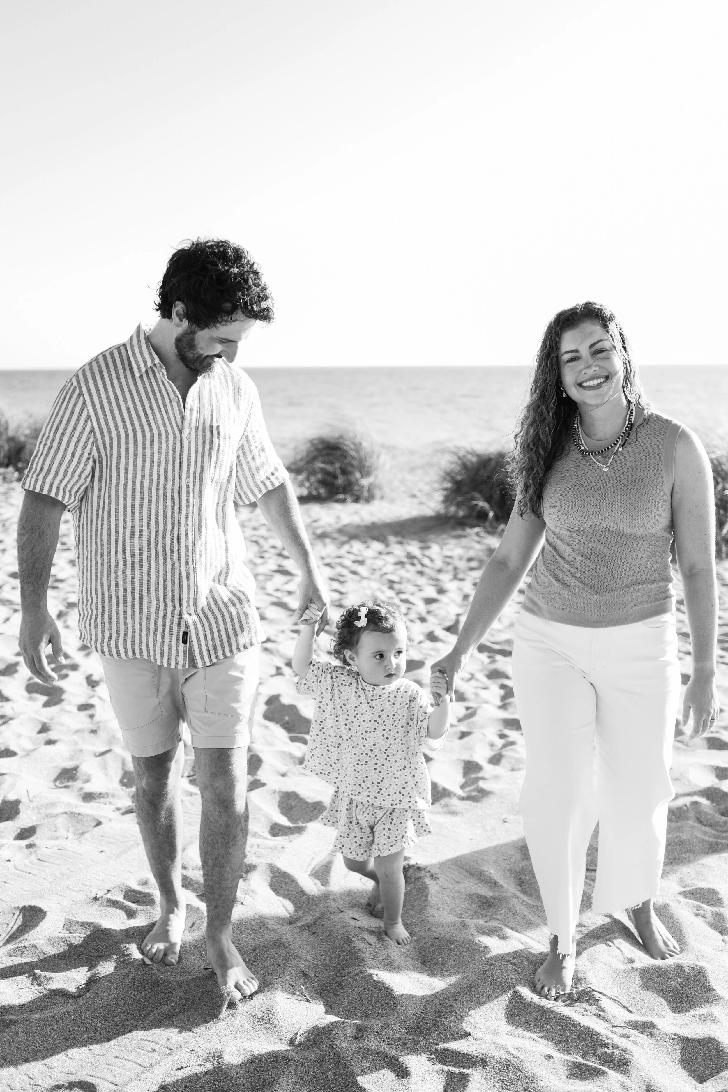 family-beach-photoshoot-venice-florida-walking-holding-toddler-black-and-white.jpg2.jpg