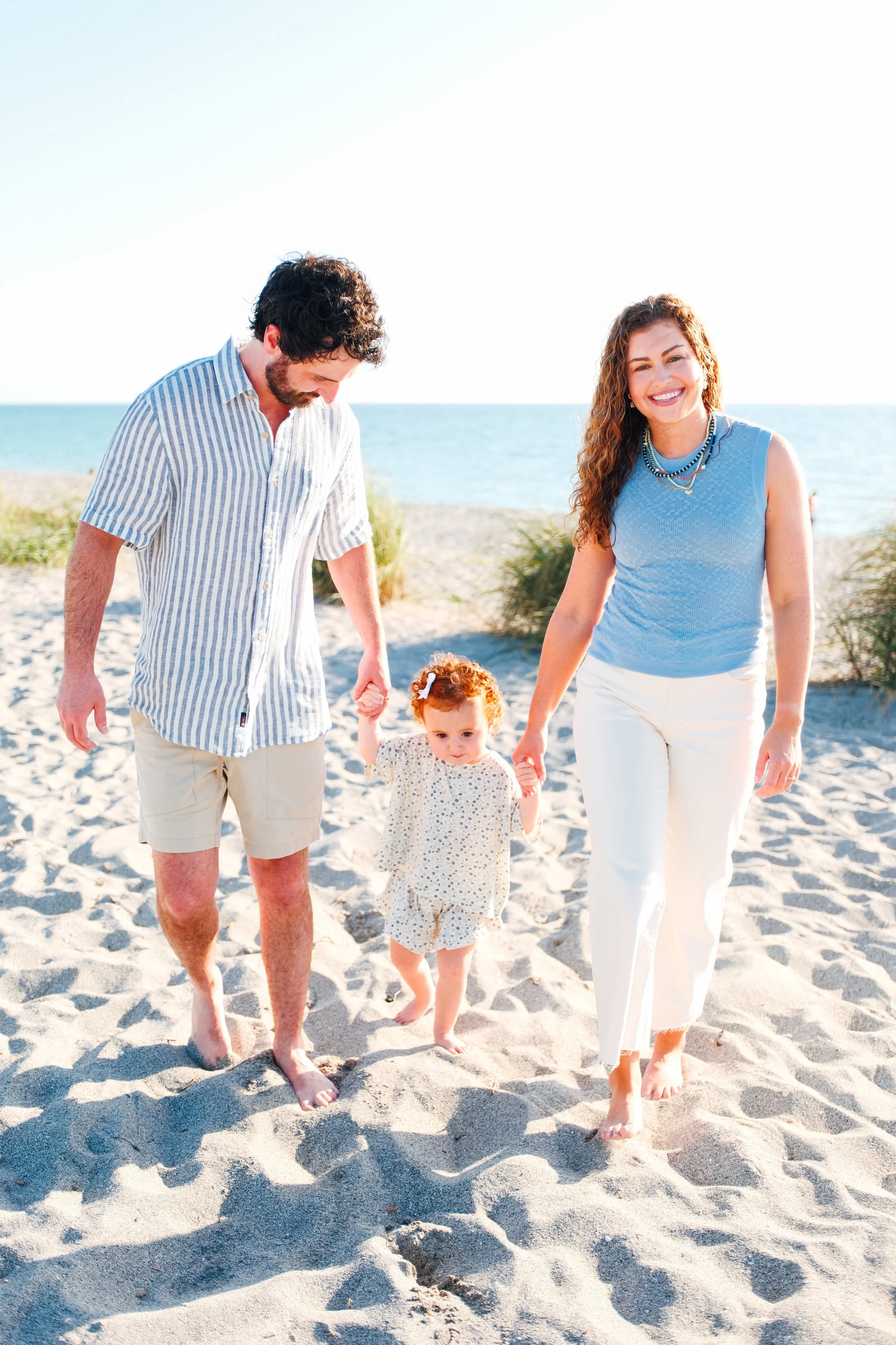 family-beach-photoshoot-venice-florida-walking-holding-toddler.jpg