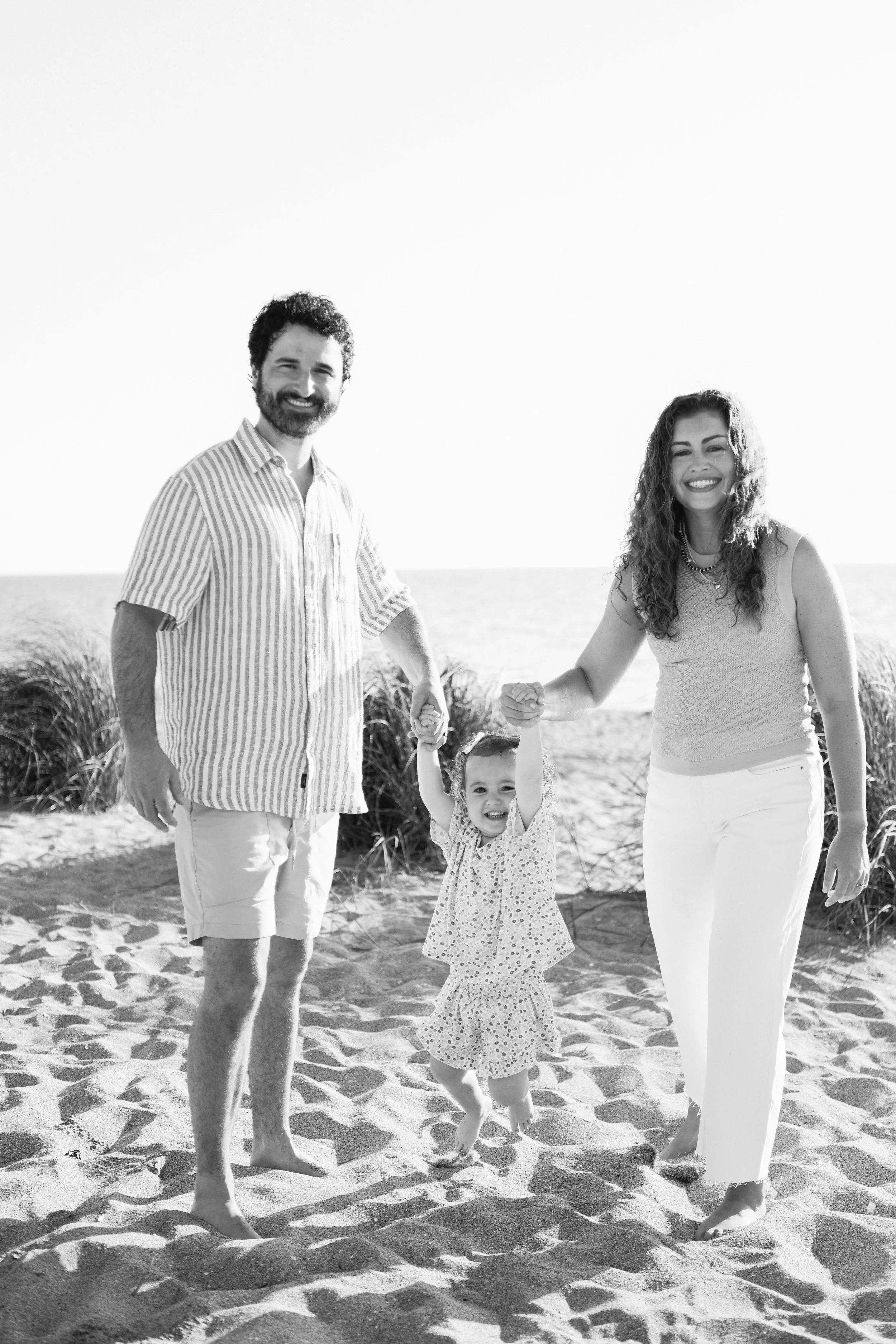 family-beach-photoshoot-venice-florida-walking-swinging-toddler-black-and-white4.jpg