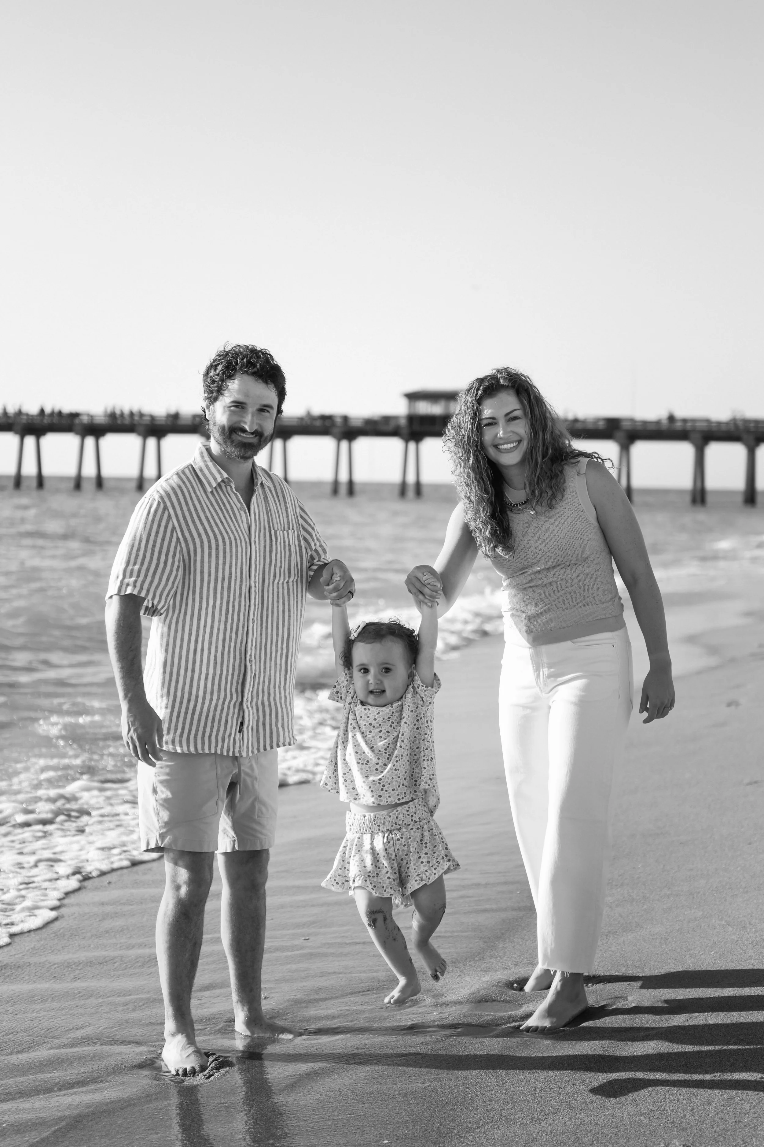 family-beach-photoshoot-venice-florida-walking-along-the-water-black-and-white3.jpg