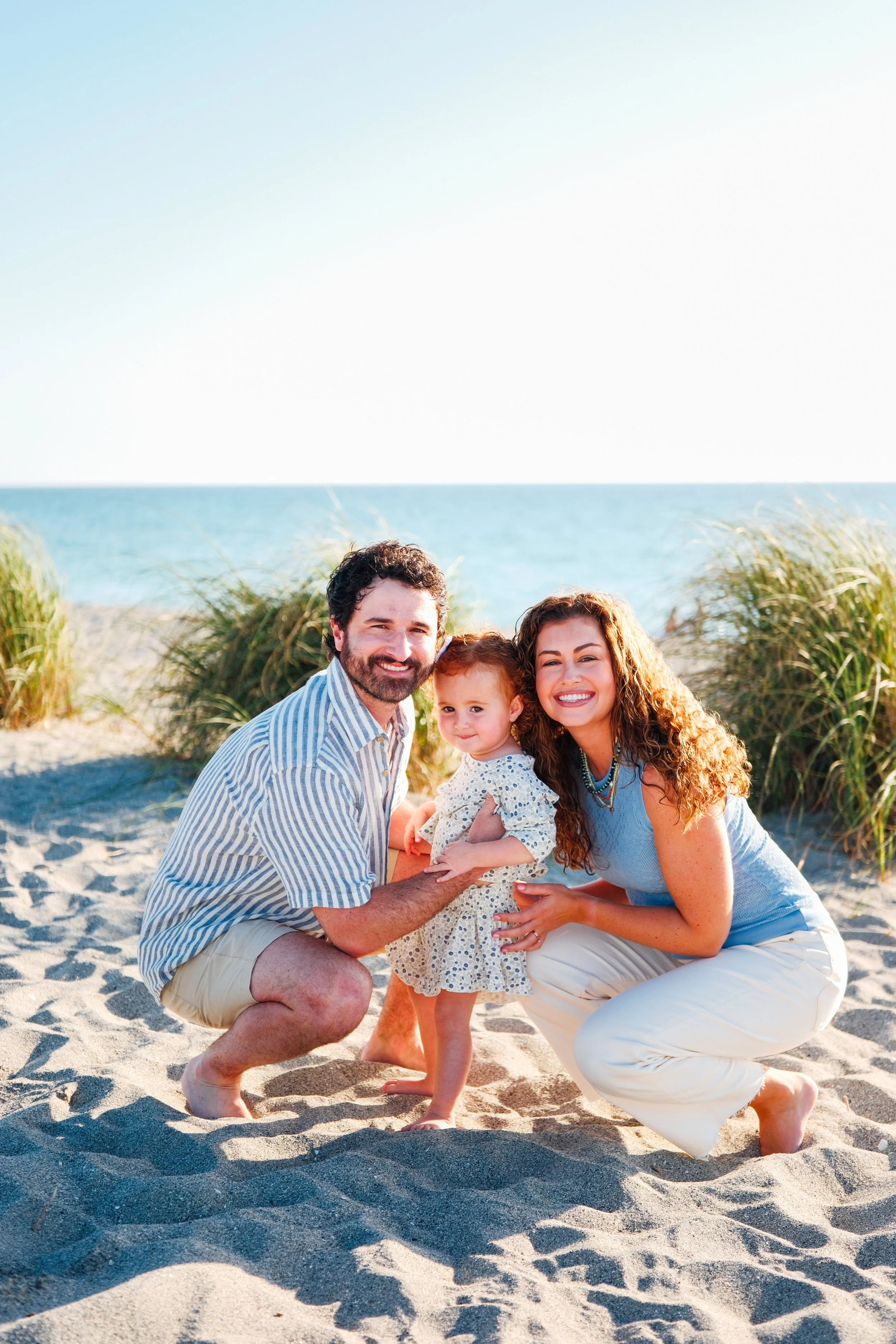 family-beach-photoshoot-venice-florida-squatting-side-by-side.jpg