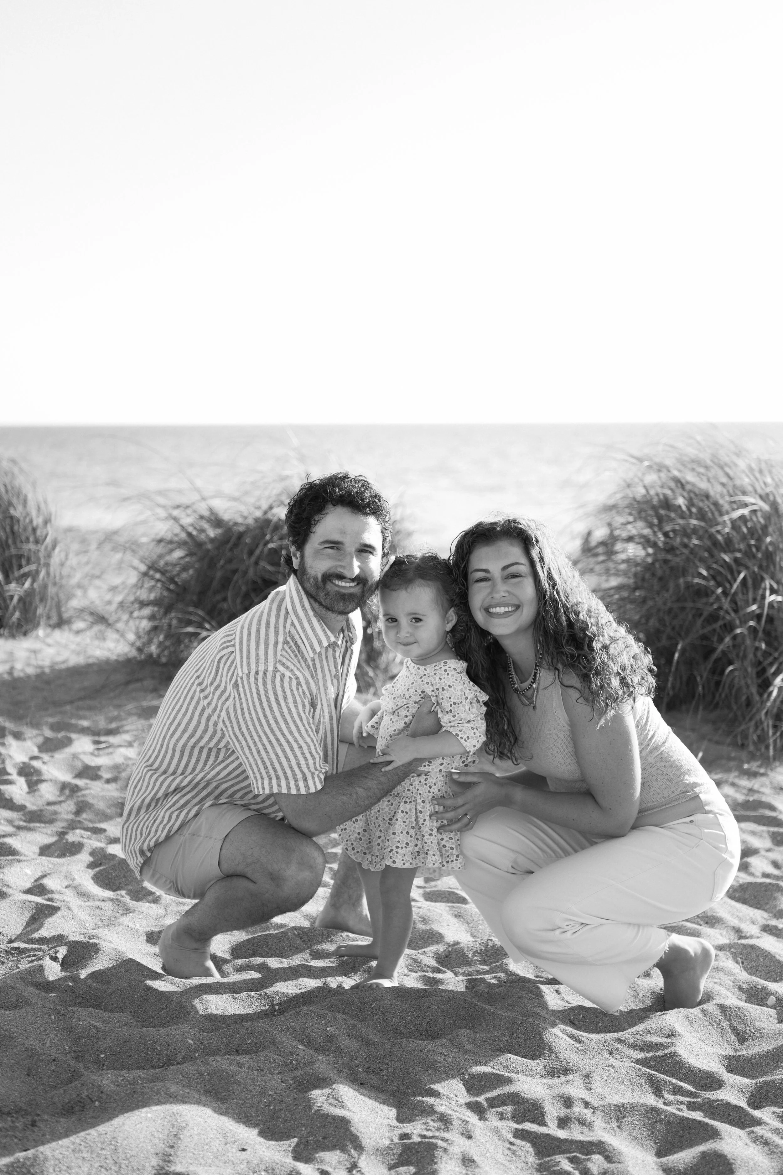family-beach-photoshoot-venice-florida-squatting-side-by-side-black-and-white.jpg