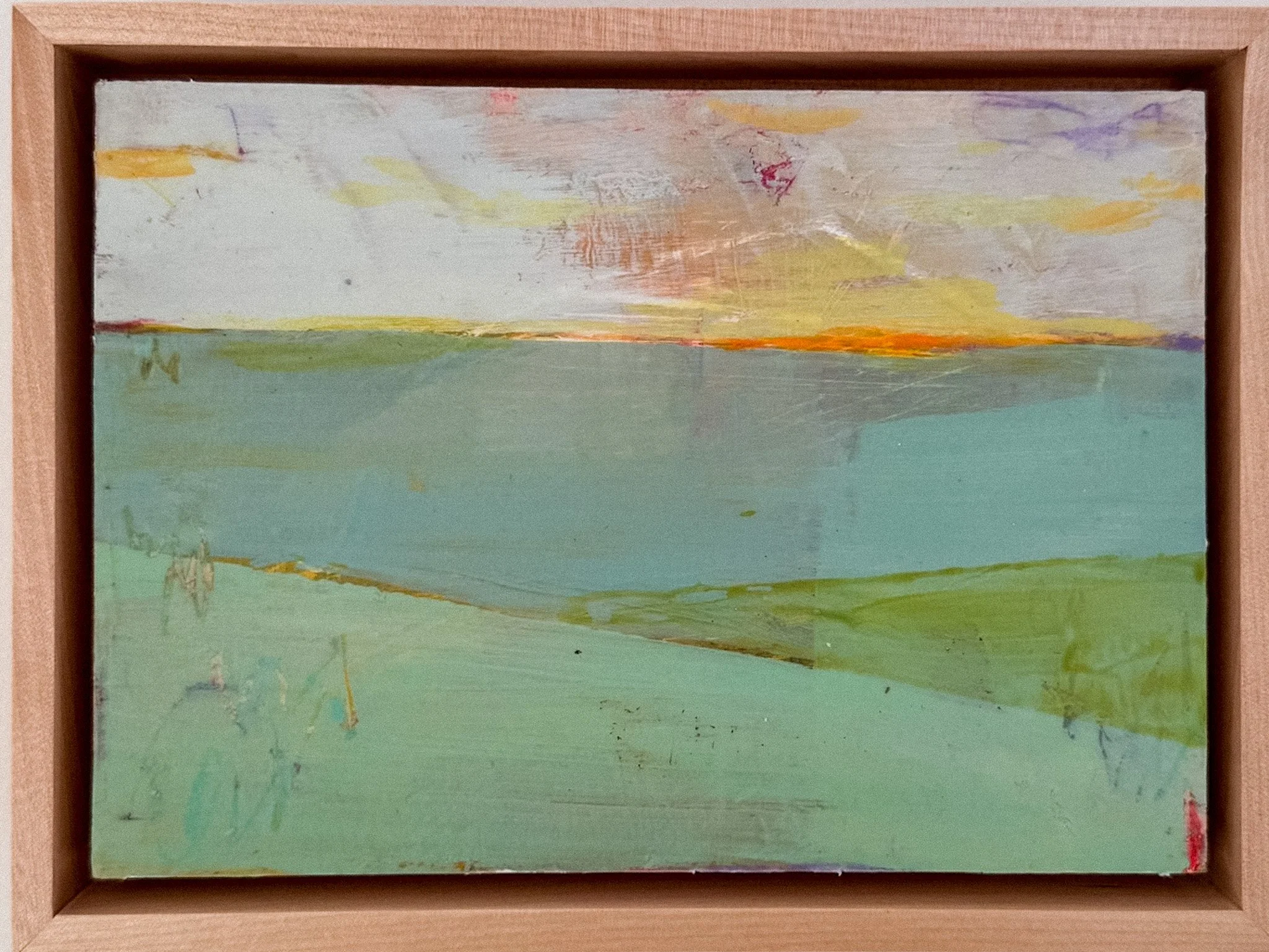 Abstract pastel-colored painting with shades of yellow, orange, purple, green, and white, enclosed in a wooden frame.