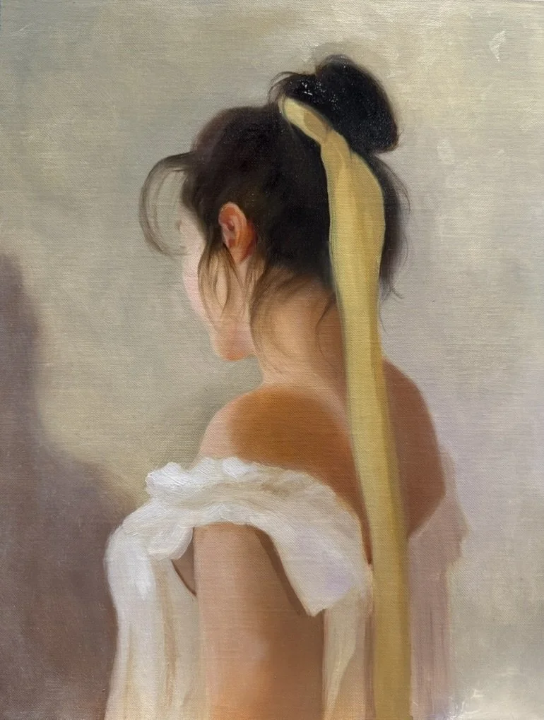 A painting of a woman with dark hair tied in a bun with a yellow ribbon, looking down, wearing a white off-shoulder garment, with a soft, blurred background.
