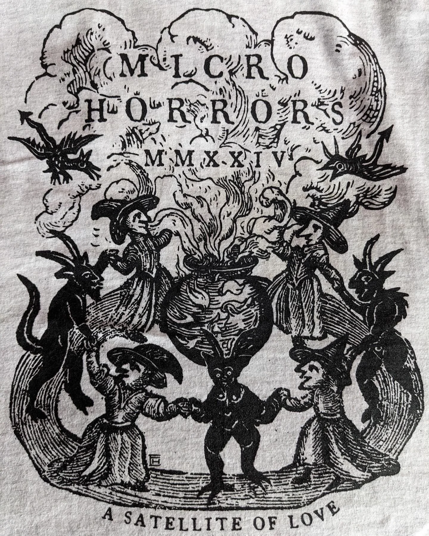 The front and back of the MicroHorrors 2024 T shirts designed by @erinhern10. 

We will talk briefly about the design at our screenings tomorrow night @asatelliteoflove and Saturday @thepalmtheatre.