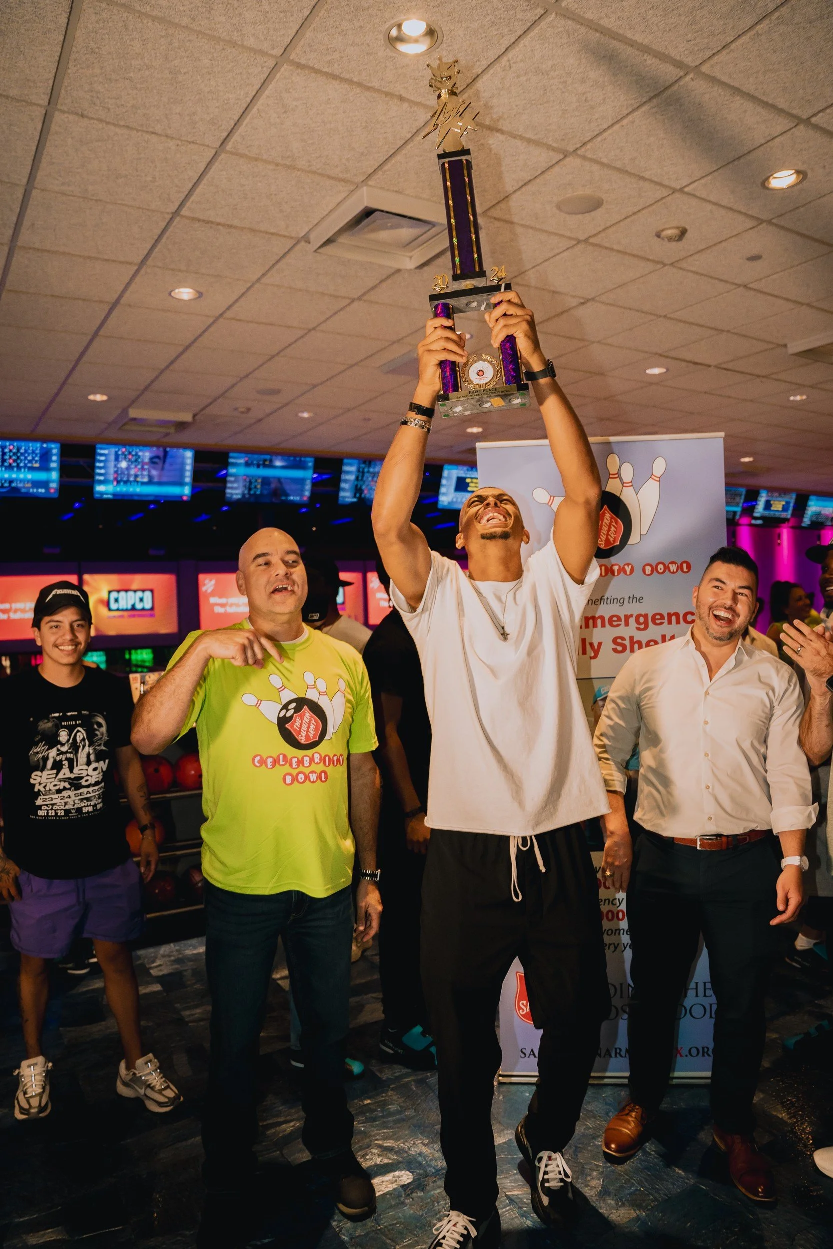 An attendee raising a trophy.