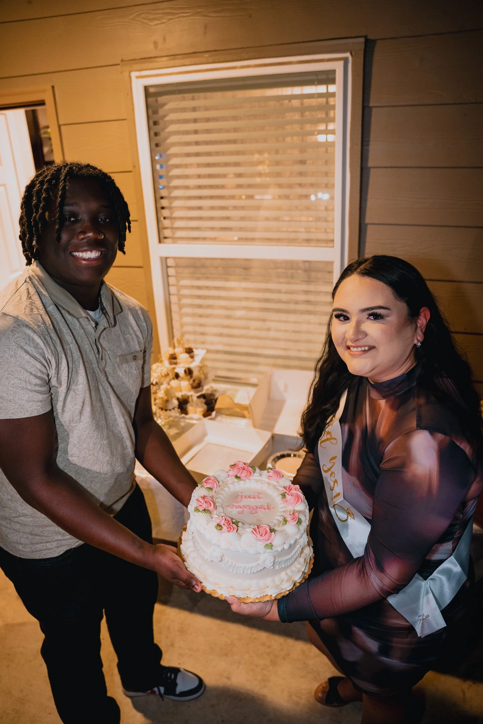 Elijah and Jill beside the celebration cake.