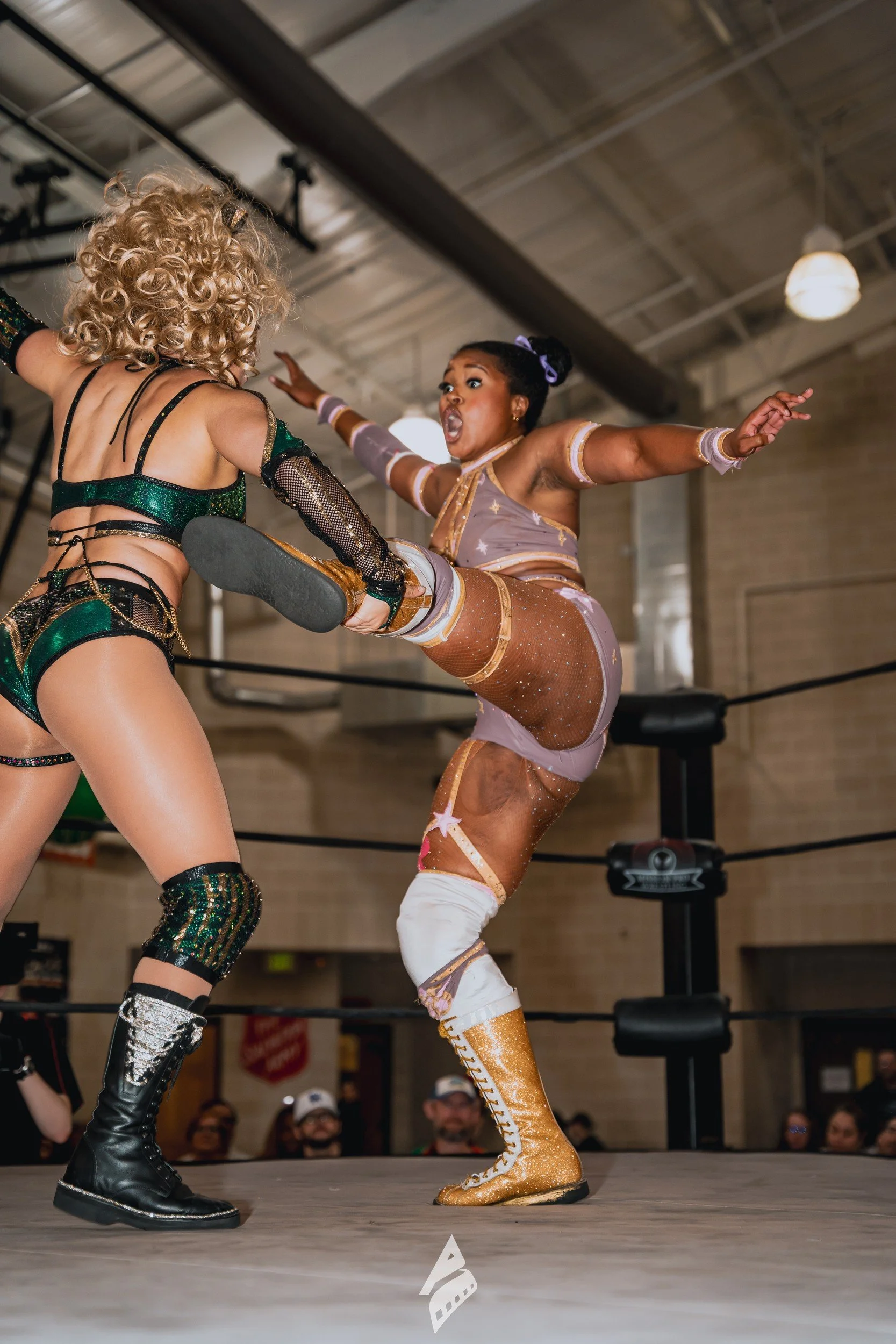Wrestler delivering a high kick.