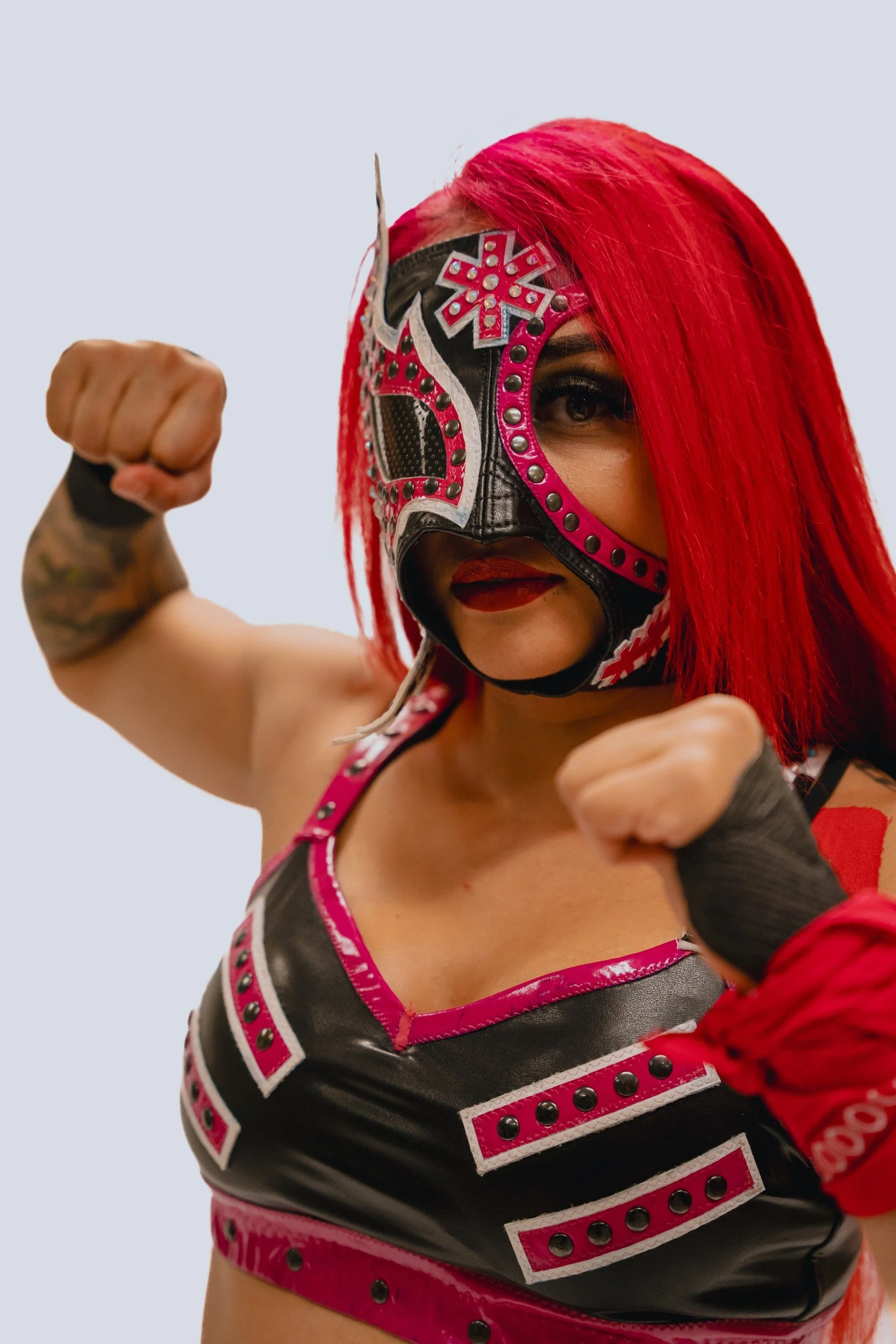 Masked performer with red hair.