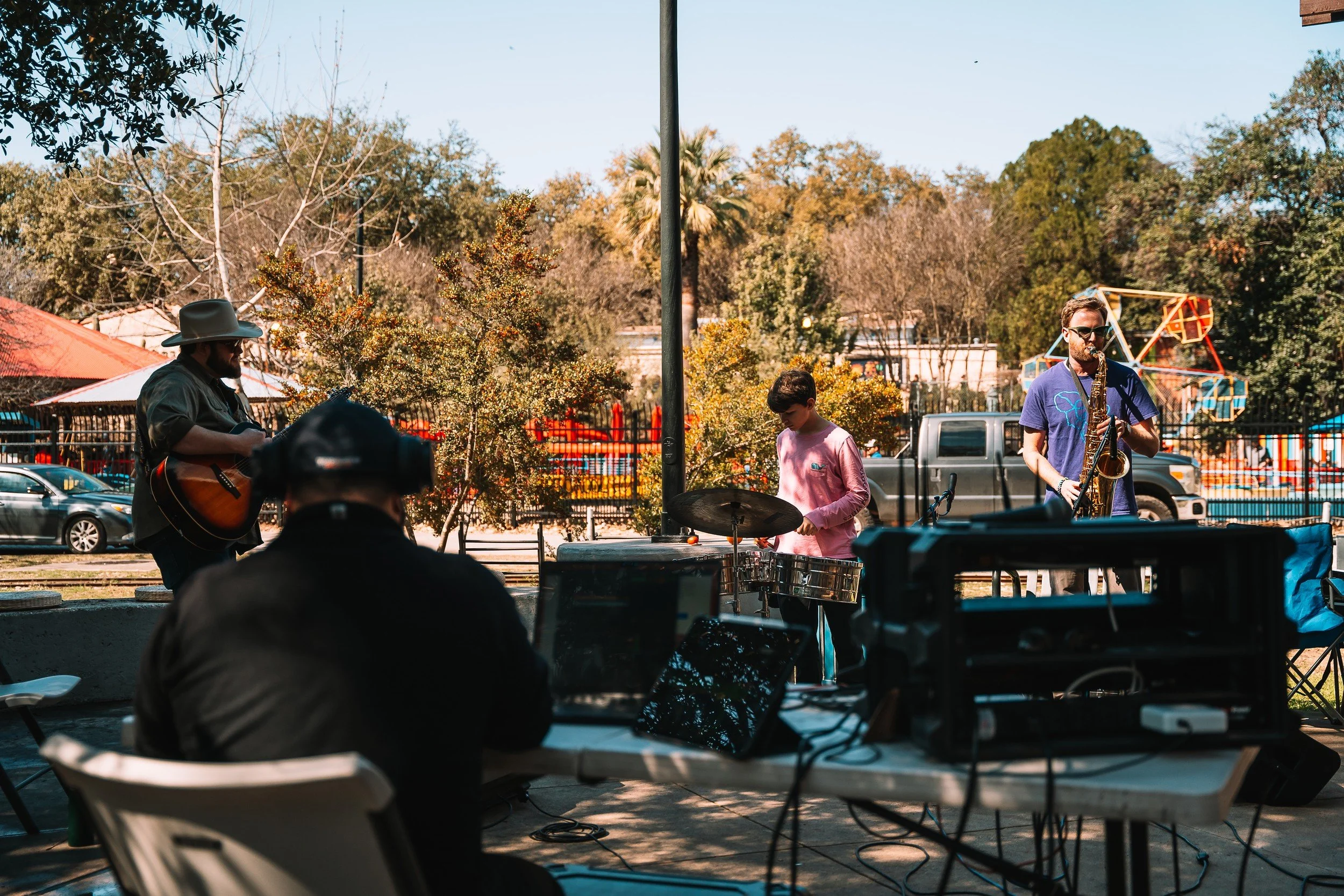 Wide view of the band performing at the Basura Bash community event.