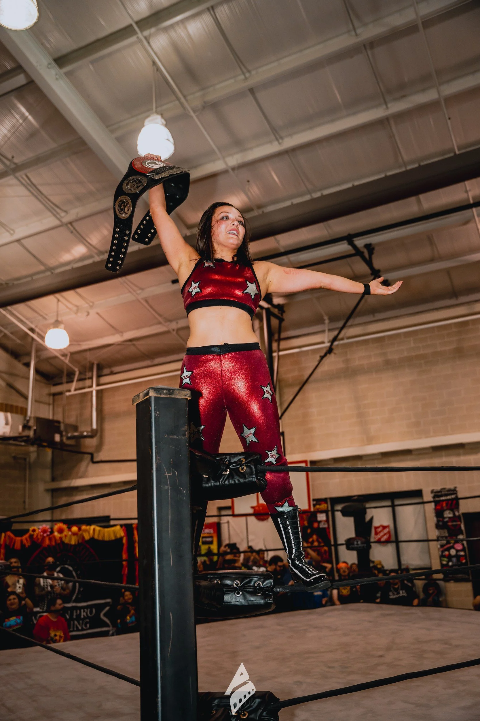 Performer raising a championship belt.