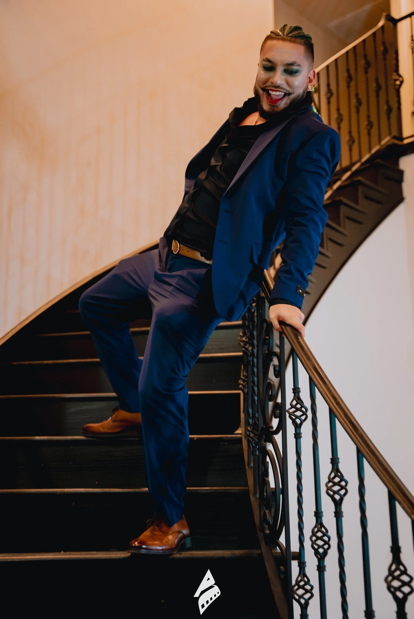 Performer posing on a staircase.