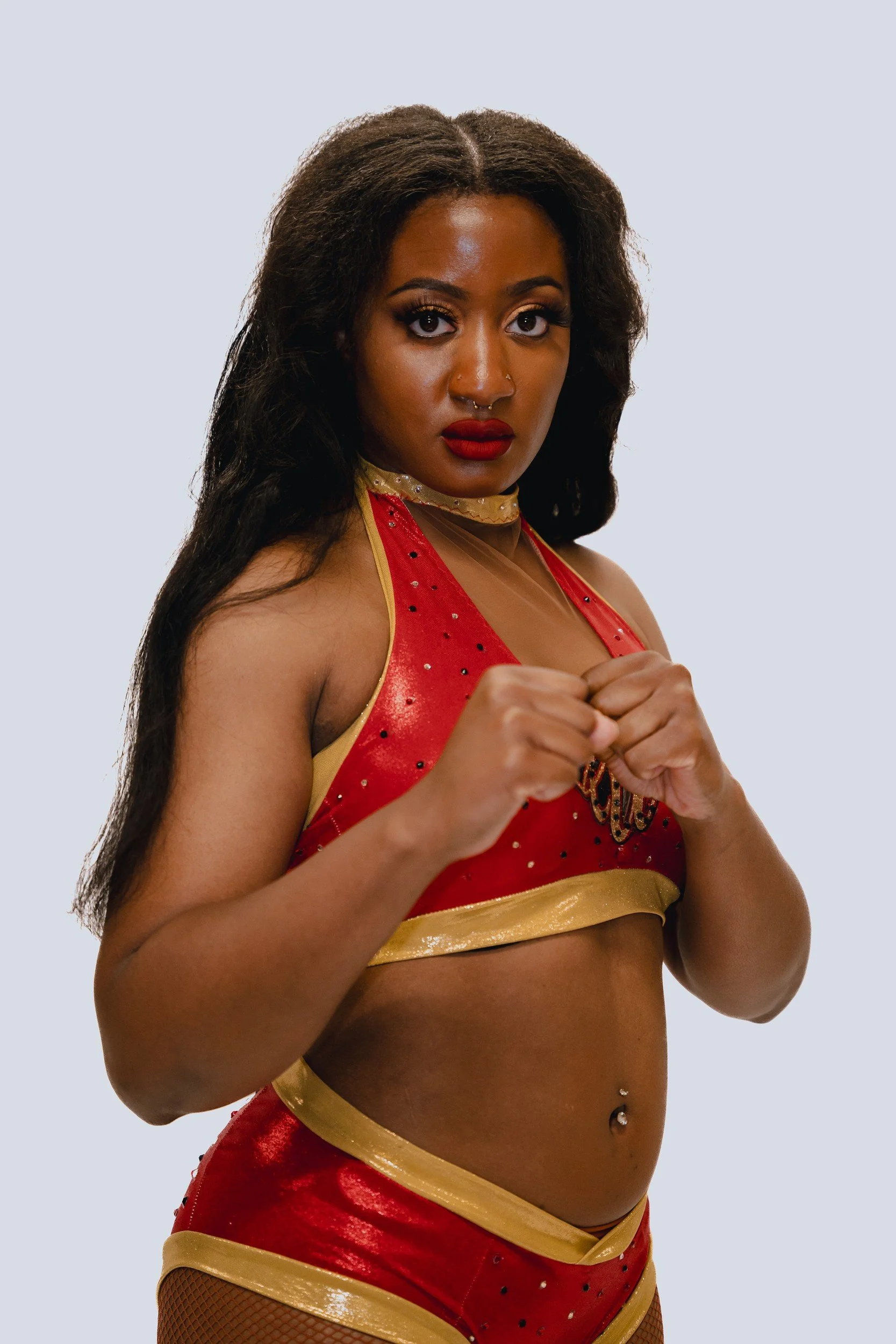 Close portrait of a performer in red and gold.