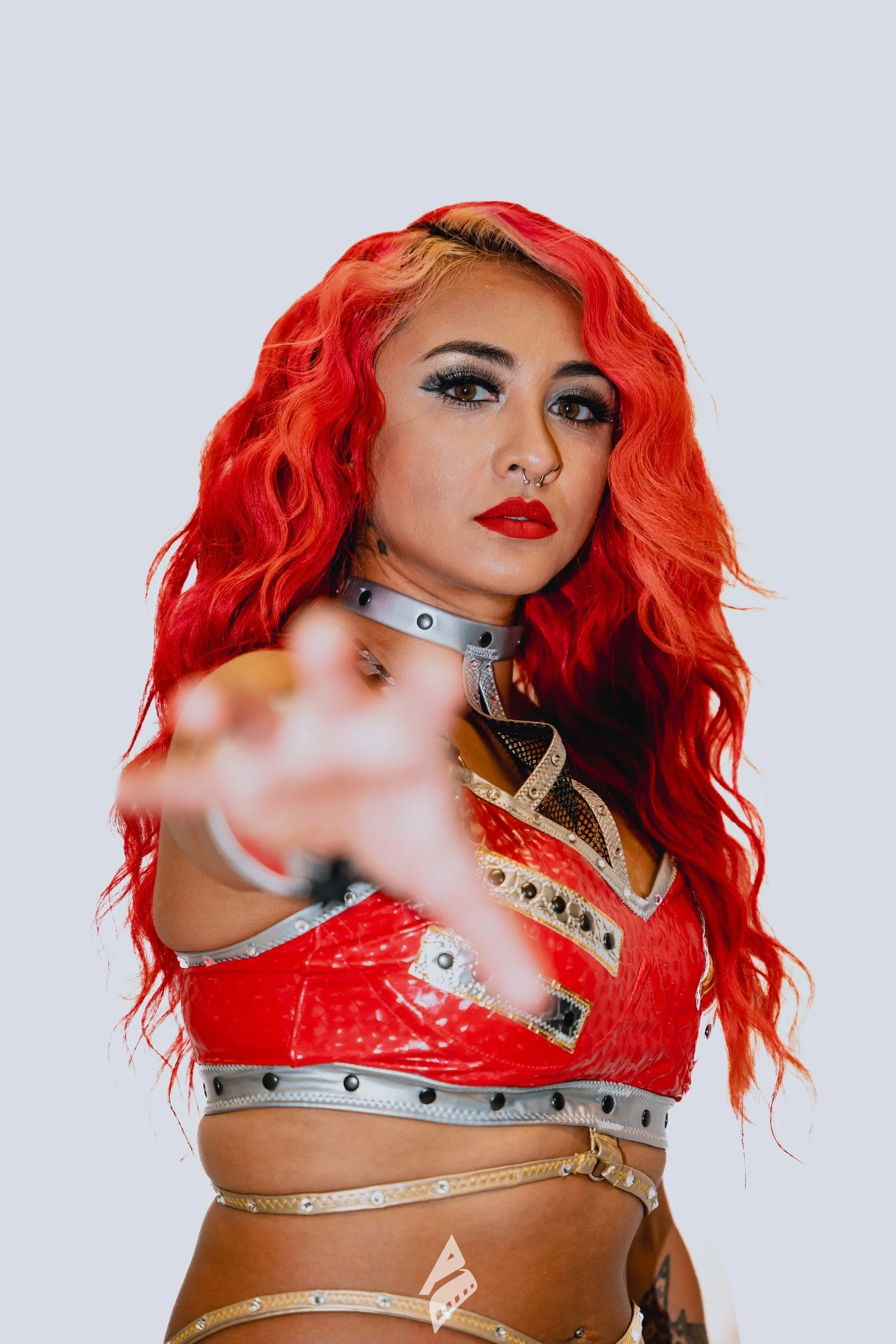 Performer reaching an outstretched hand toward the camera.