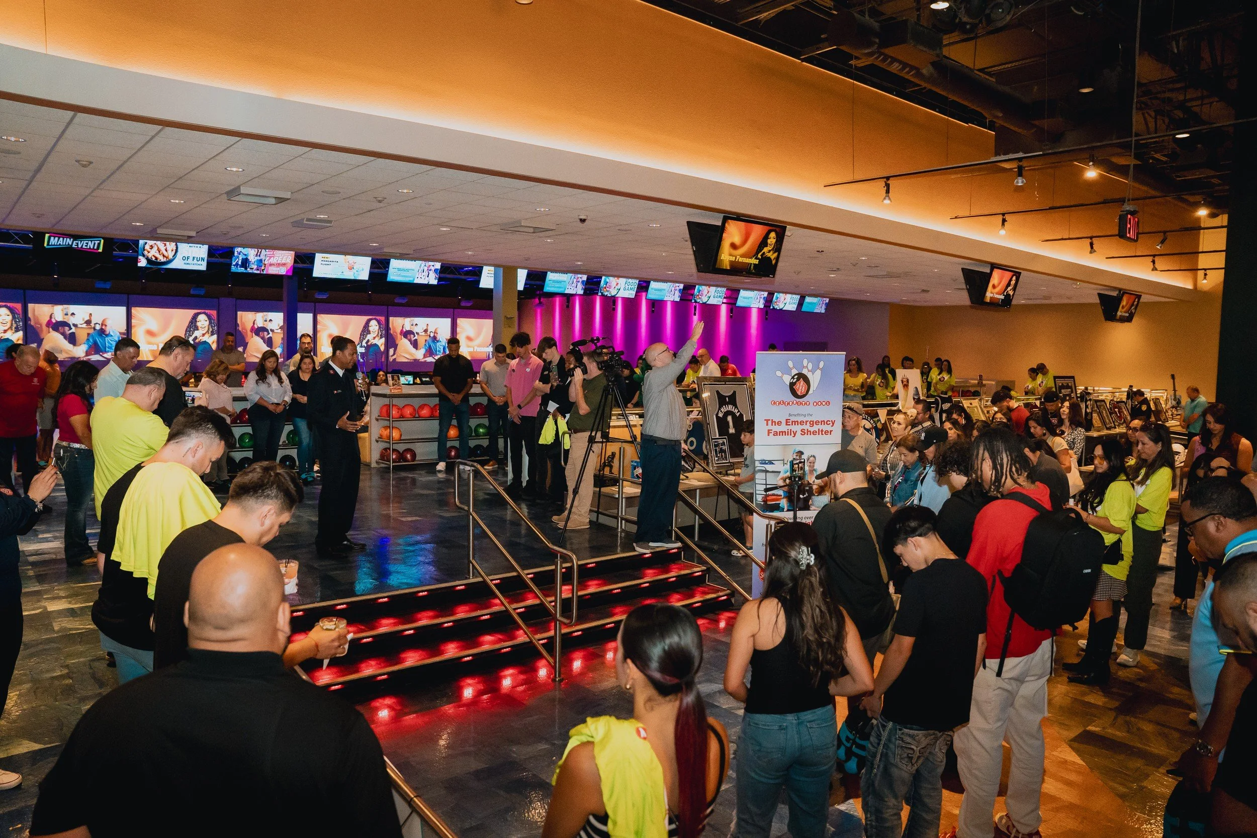 Wide view of the bowling event and crowd.