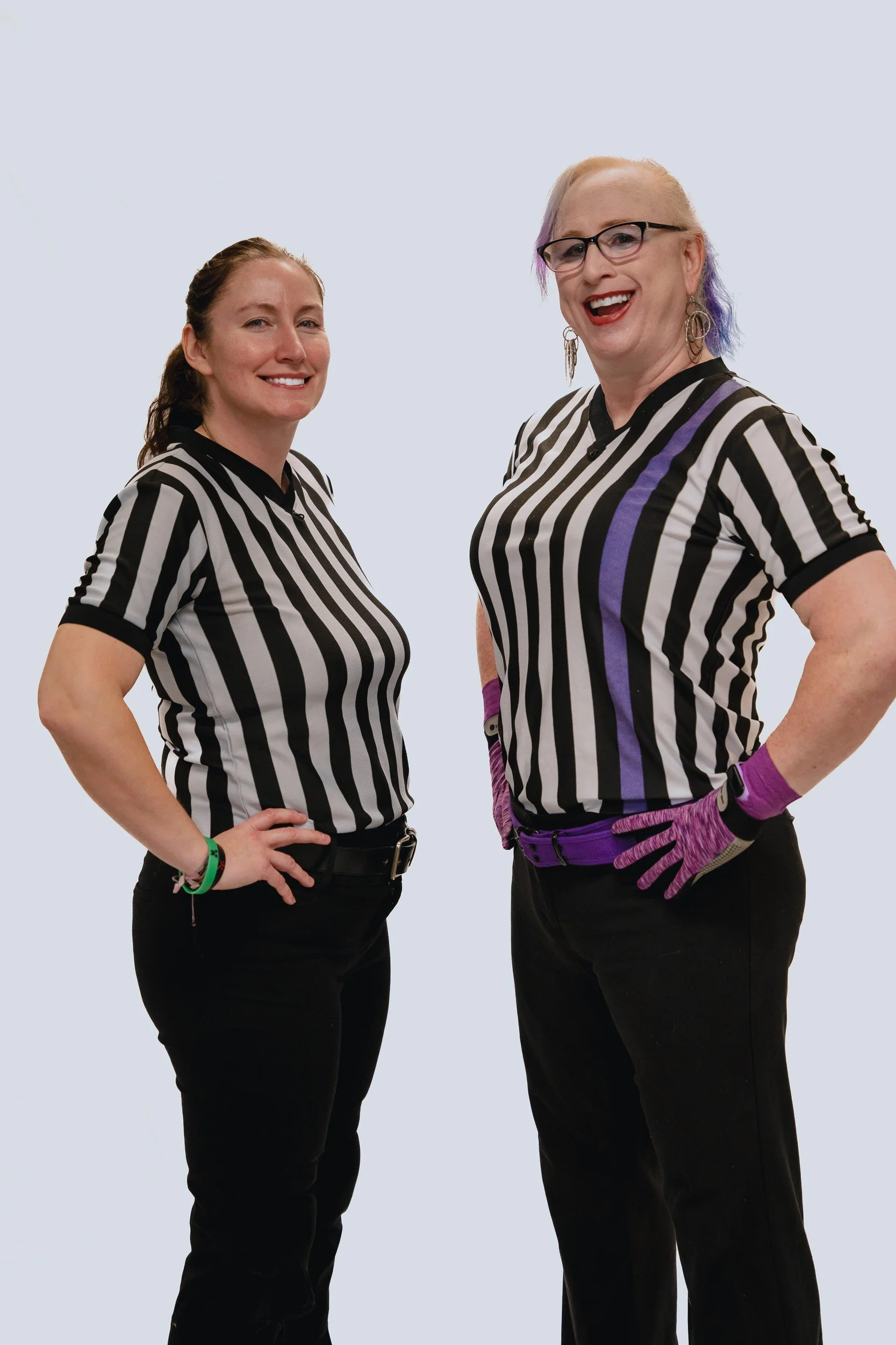 Two referees posing together.