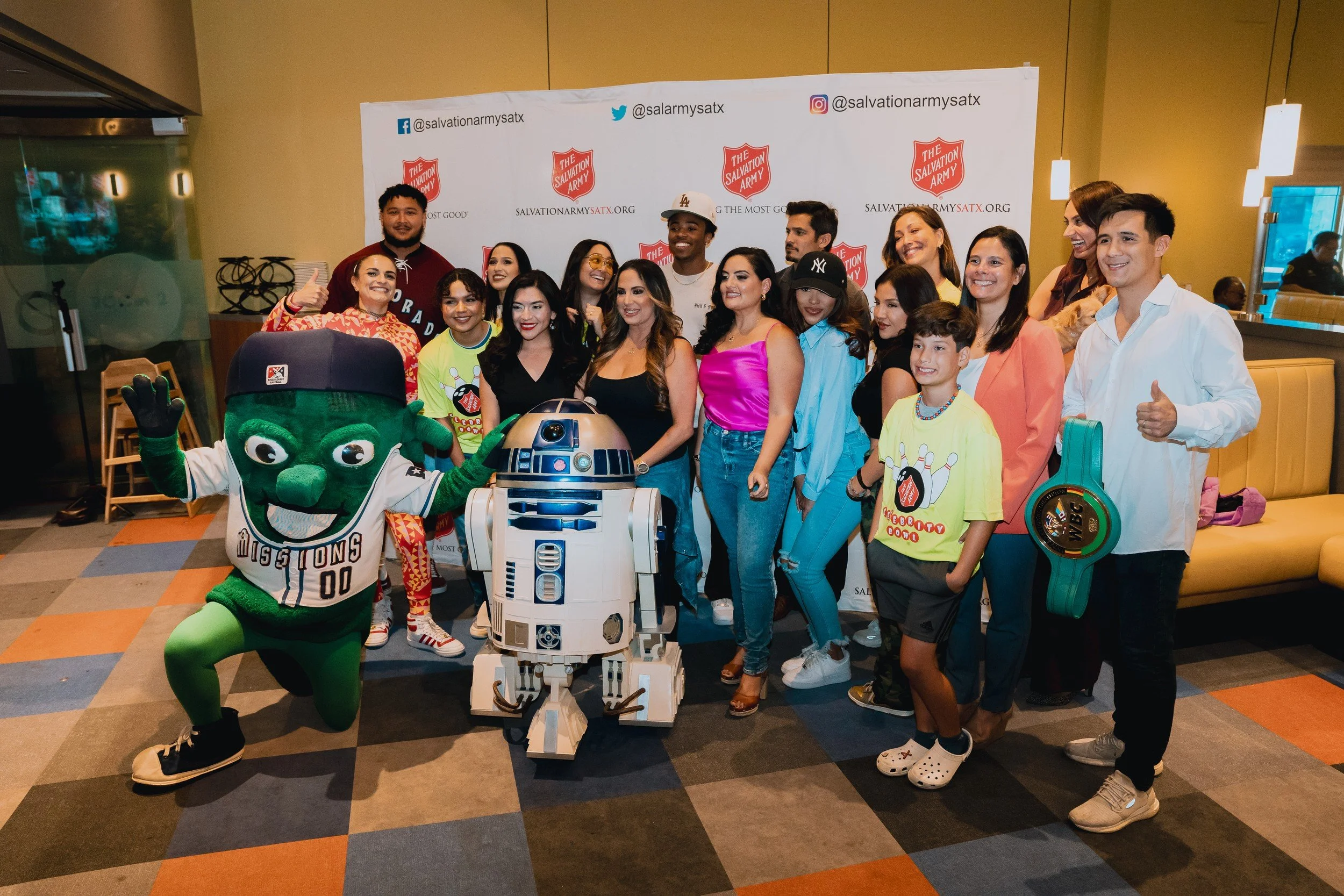 Group portrait beside the event backdrop.