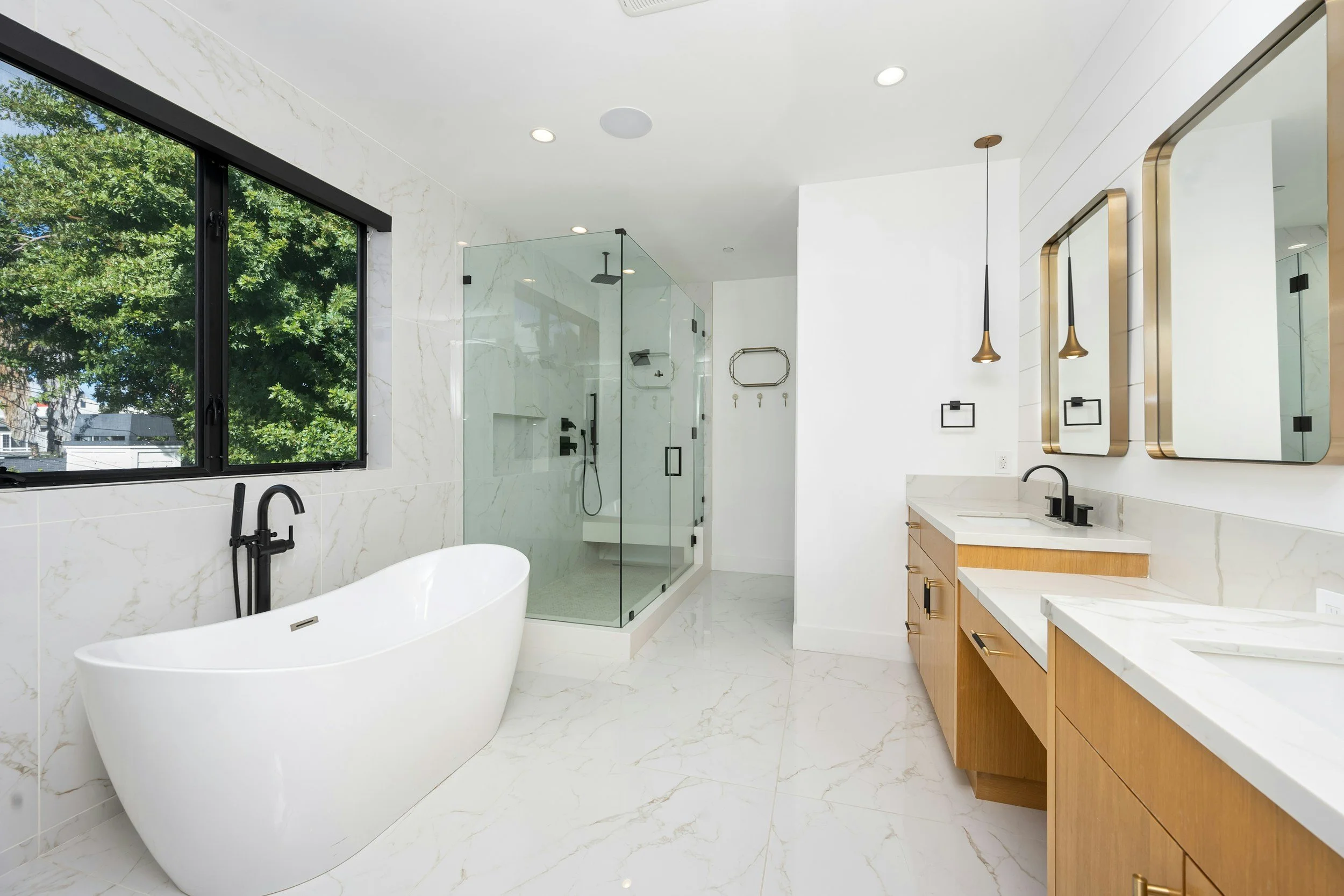 Modern bath, soaking tub. stand up shower with bench. updated lighting and plumbing. double vanity.