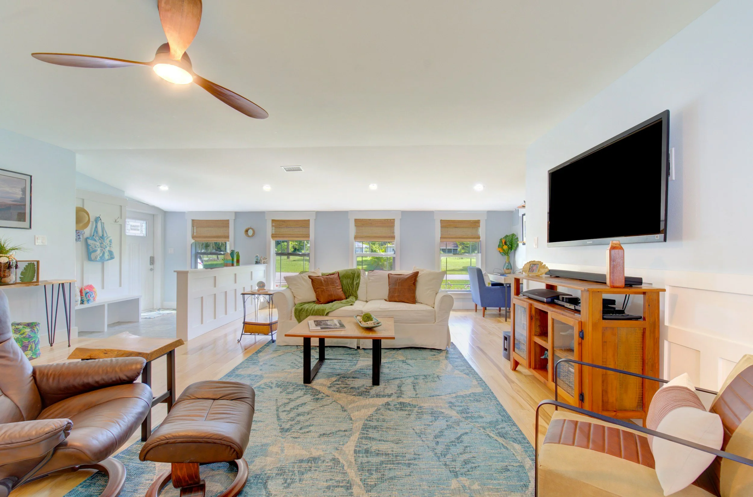 walk-out basement remodel. White ceilings with wafer lighting in soffit. Wood flooring throughout.