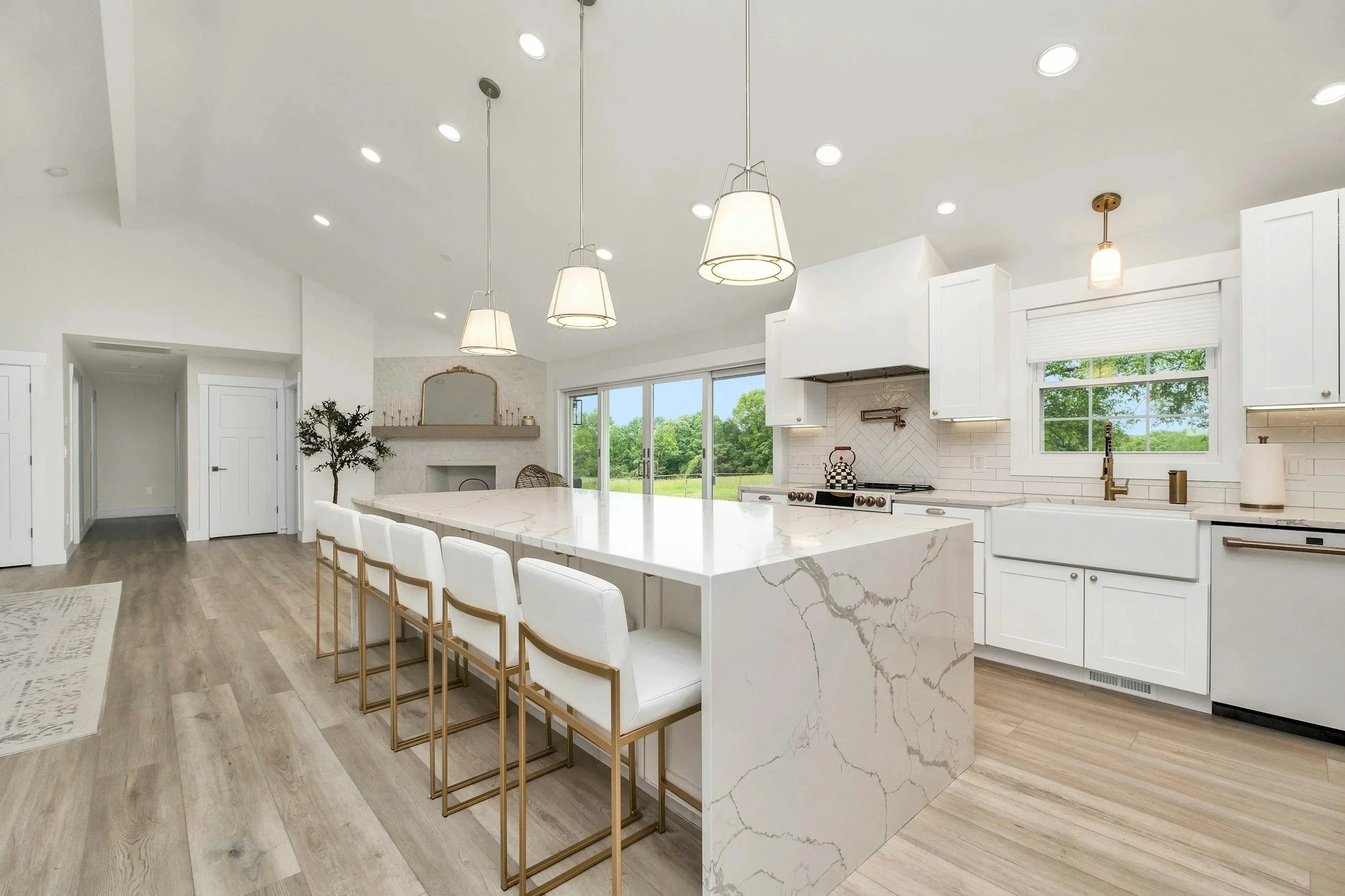 updated kitchen with waterfall island top marble throughout. updated lighting and farmhouse sink