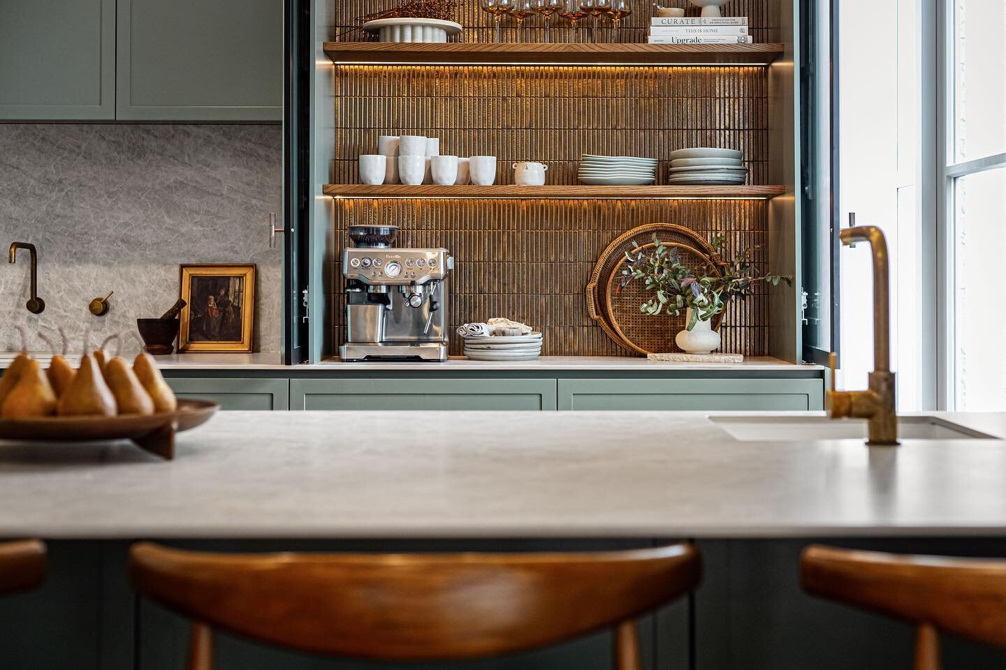 Beautiful design by Kate Gardham / Suede+Stone. 🌿✨ Green &amp; Brass Delight! 🍽️💚 Step into this kitchen oasis, where soft pastels and ceramic benchtops create a serene ambiance. The calming hues of green paired with brass accents add a touch of s