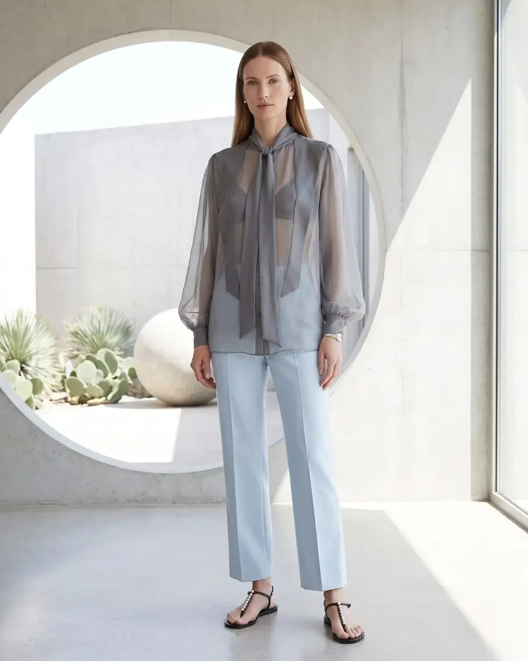 Sheer grey-blue silk blouse with light blue cropped trousers — sheer blouse outfit ideas from the Dalí-inspired spring capsule wardrobe.