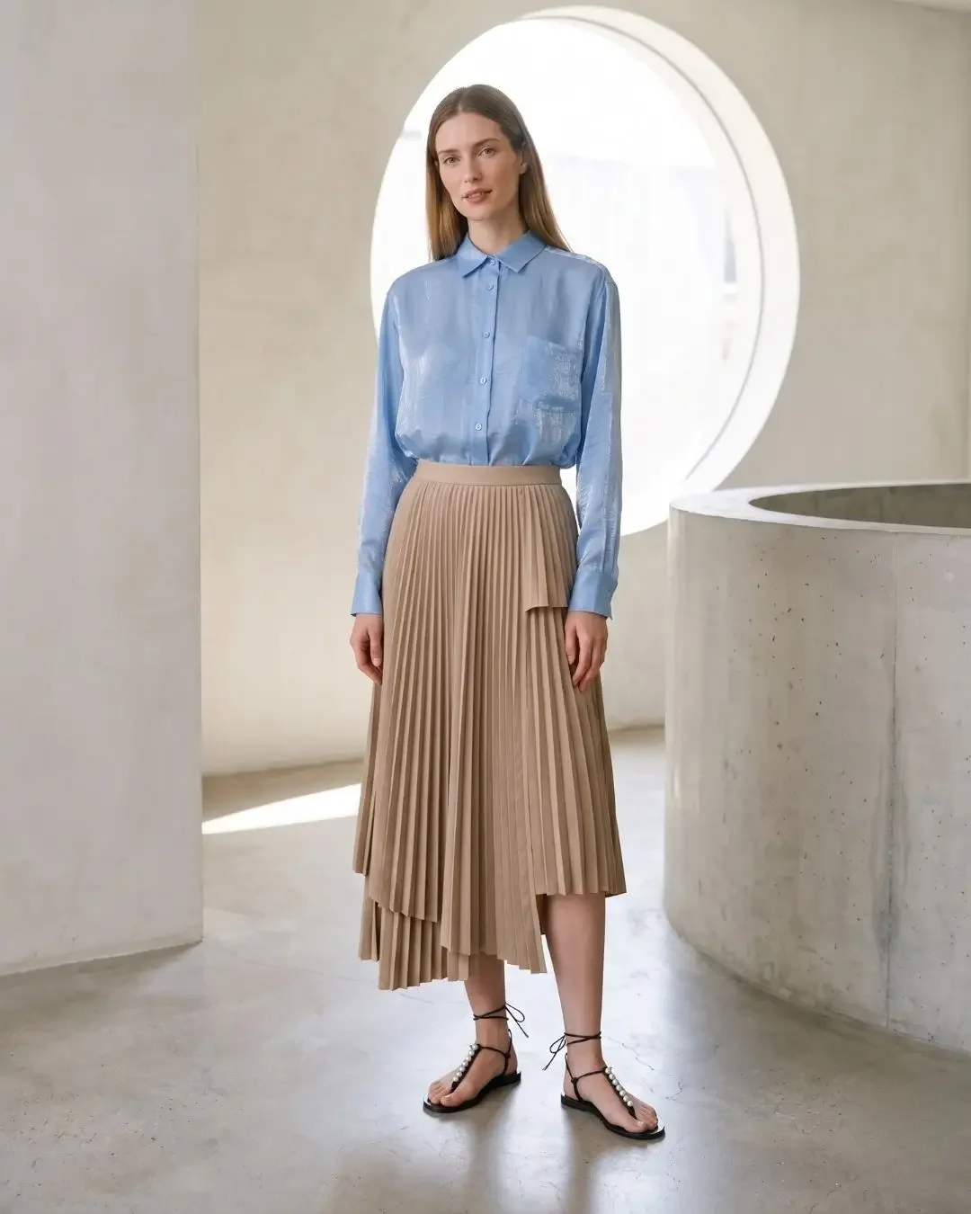 Light blue silk shirt with beige asymmetric pleated skirt — pleated skirt outfits, Wonder Wardrobe spring capsule wardrobe 2026.