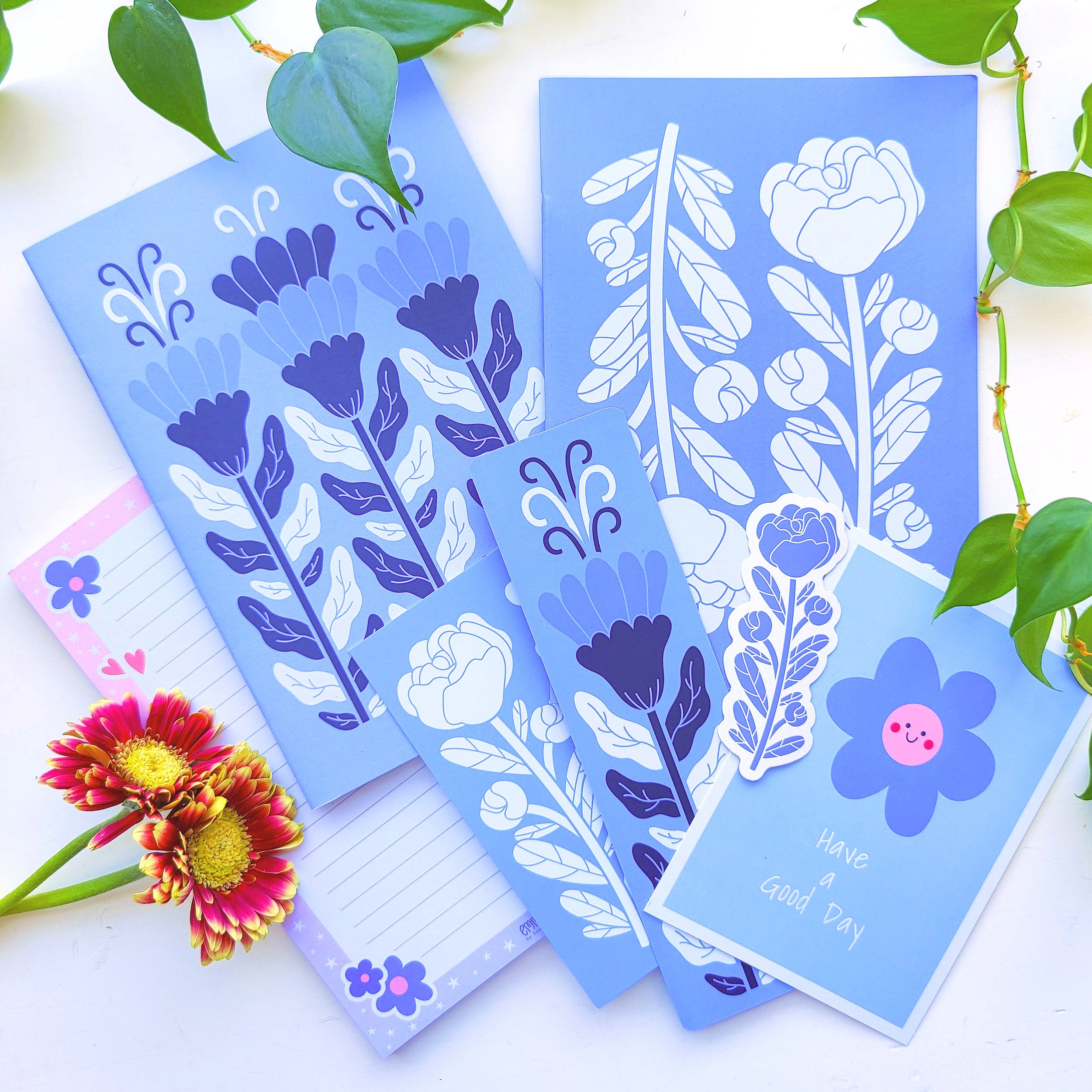 Cute paper products set in vibrant blue. Finnish design. High-quality notebooks and letterpads. Gift idea for Father's Day. Illustrated postcards, bookmarks vinyl stickers with blue flowers.