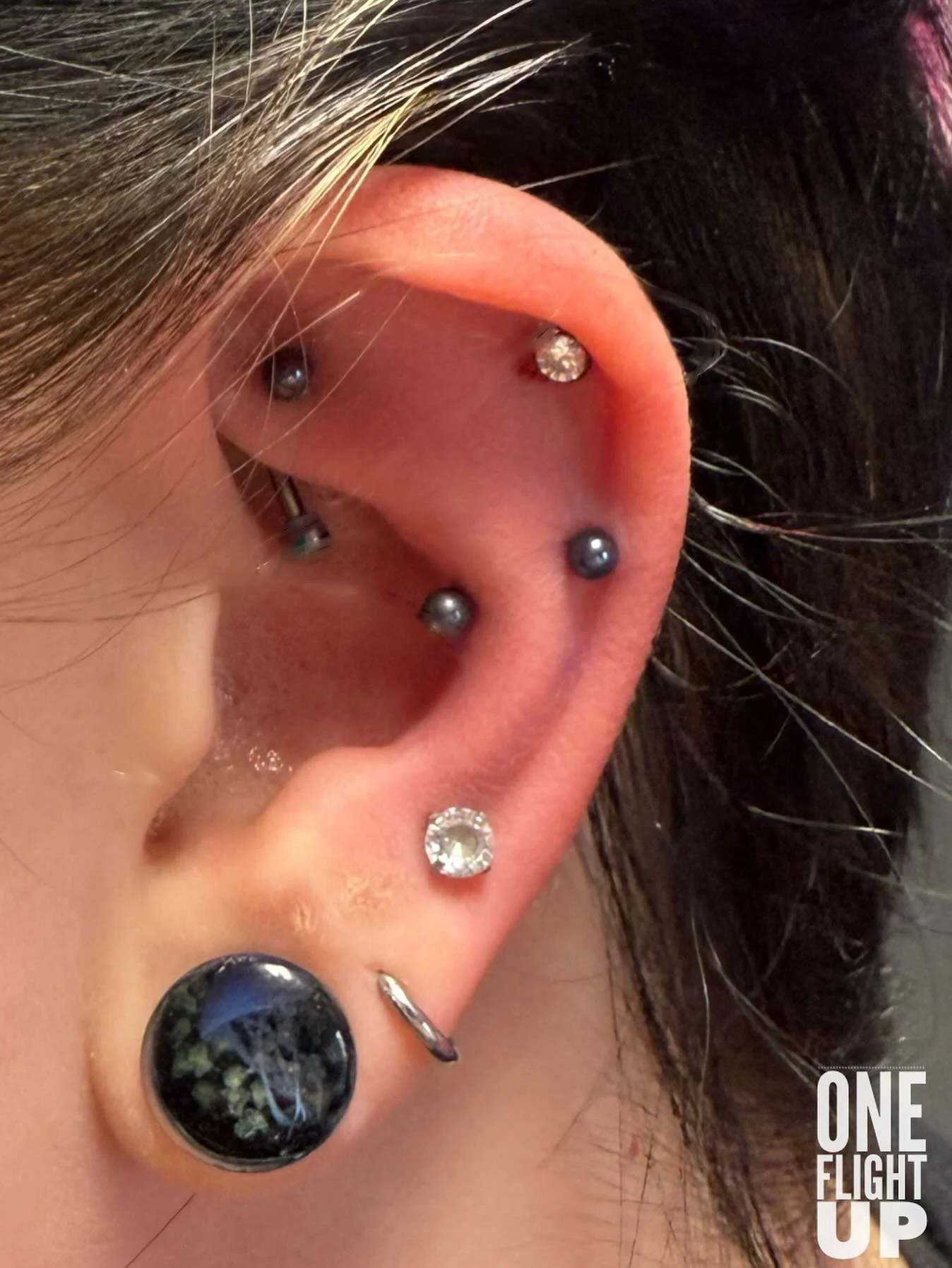 Faux snugs are one of my favorite things to do you we combine two straight helix piercings to give the illusion that it is going through the ridge of the conch you get all the look of a snug piercing without the absolute nightmare of trying to heal a