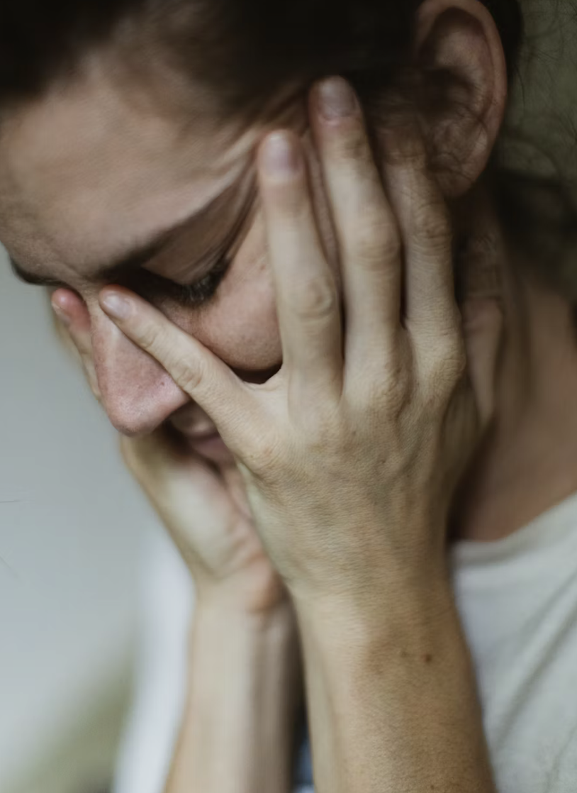 A woman with her head in her hands
