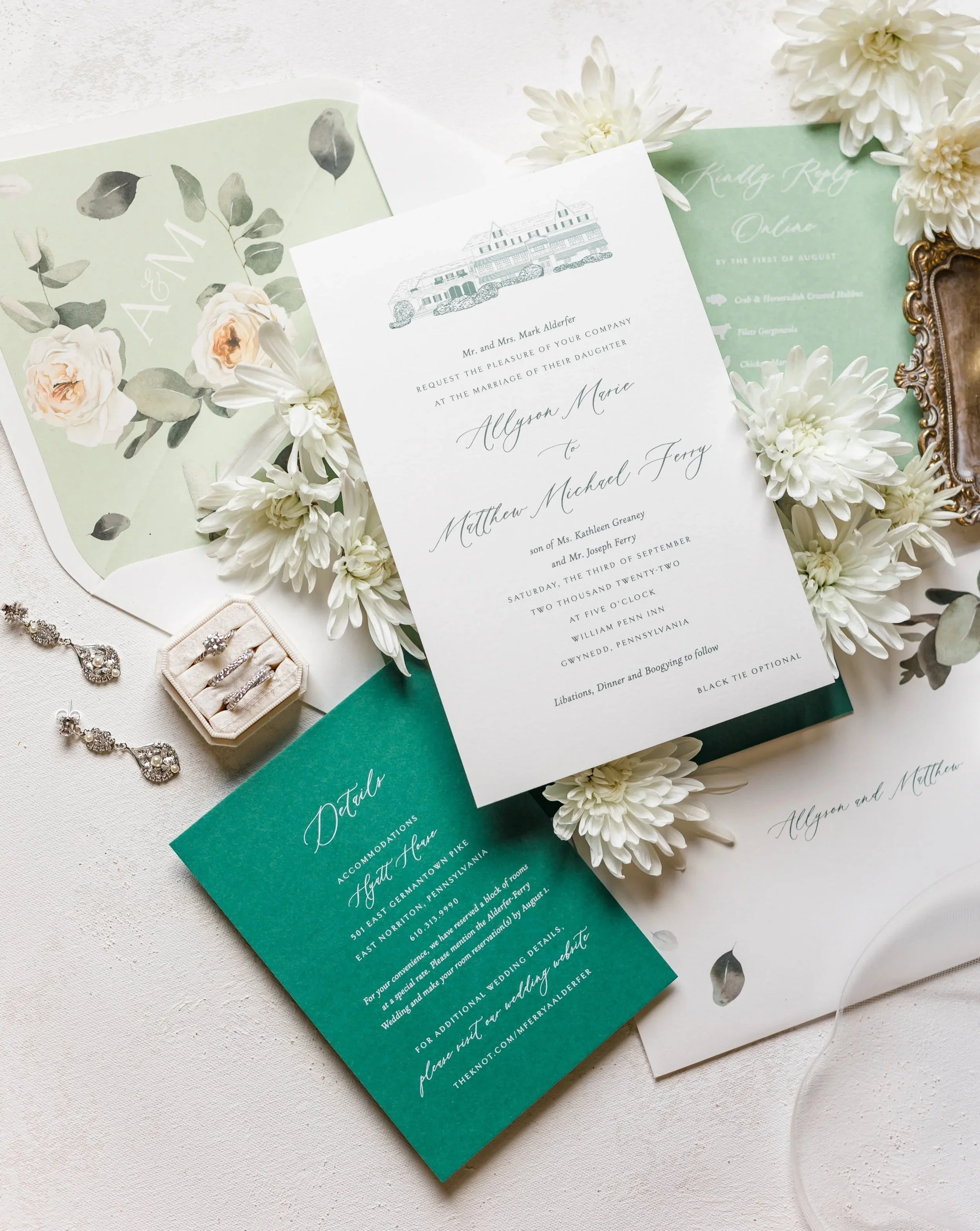 Custom designed wedding invitation with an illustration of the William Penn Inn, watercolor floral envelope liner, and shades of green.