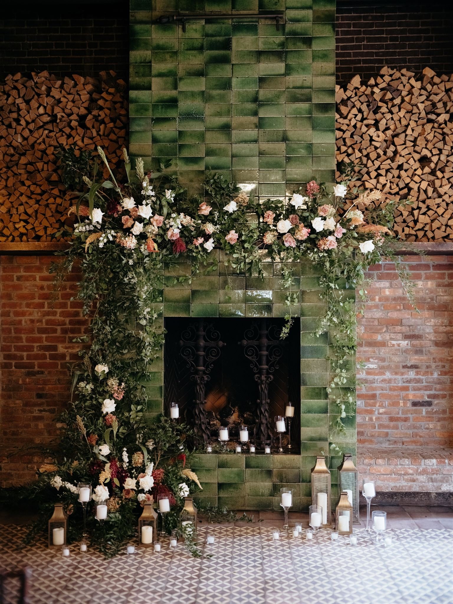 Floral-adorned, green ceramic brick fireplace