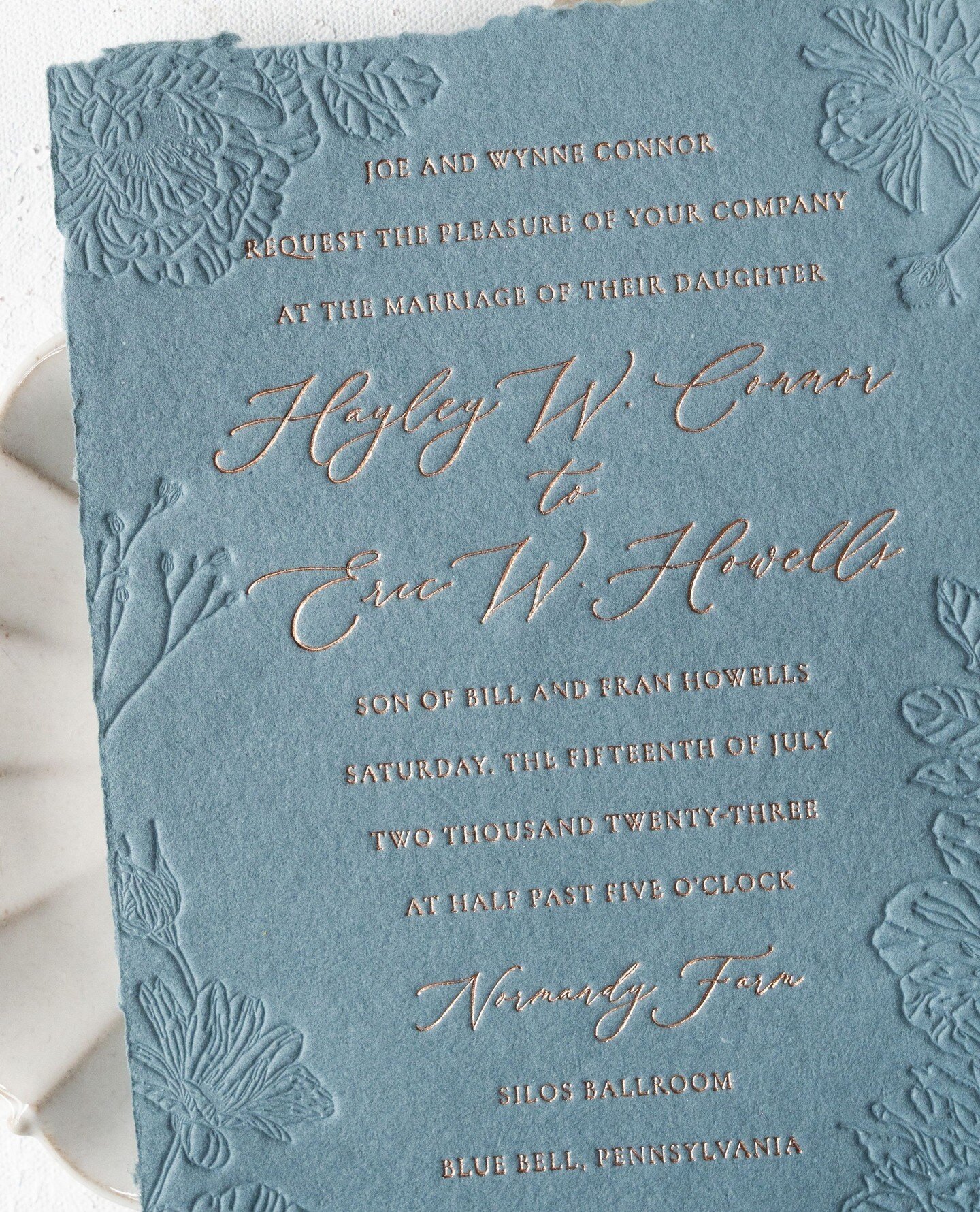 Texture matters.⁠
⁠
Handcrafted on slate blue paper with delicate rose gold foil and blind debossed florals, this invitation offers a tactile experience like no other.⁠
⁠
Photo: @peterson.design.photo