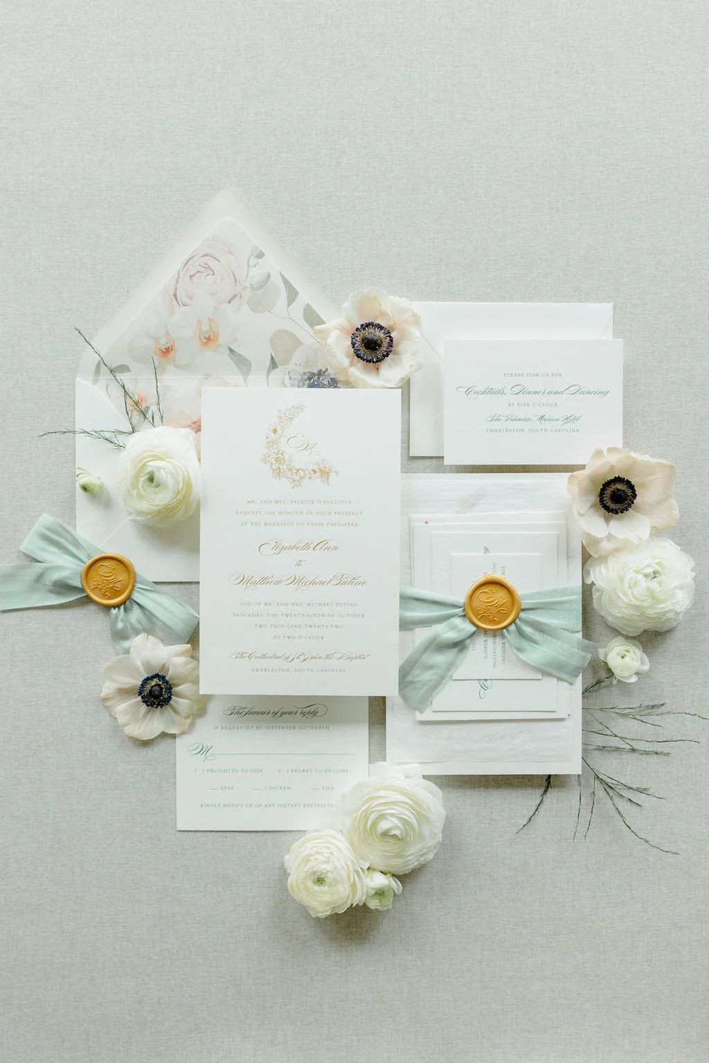 Beautiful wedding invitation suite with gold embossing, a silk ribbon, gold wax seal, and watercolor floral envelope liner. Created for a wedding at the Francis Marion Hotel in Charleston, SC