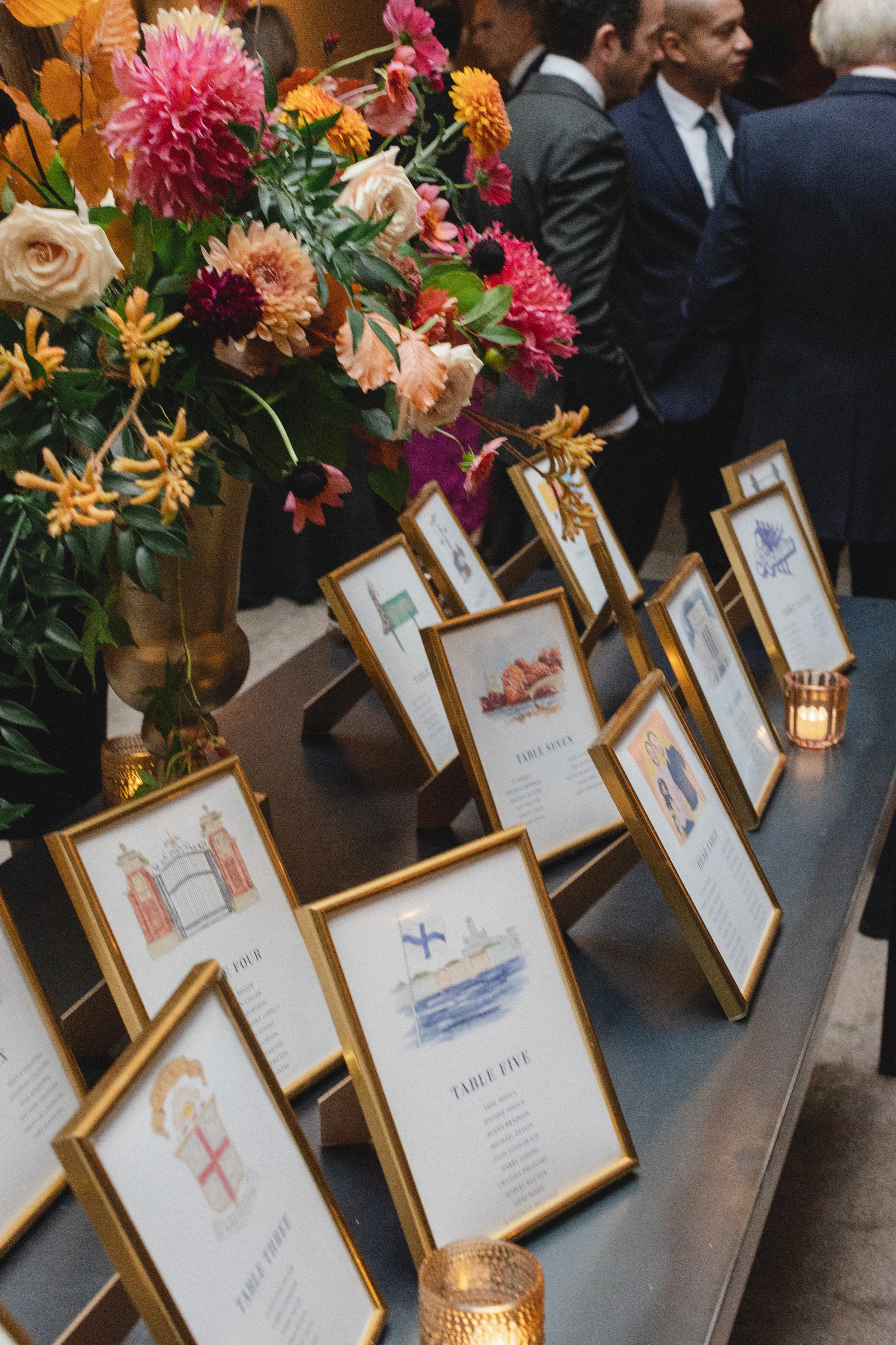 Framed seating charts with custom illustrations on each seating chart.