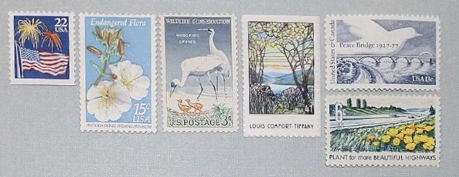 curated selection of vintage postage on a gray envelope