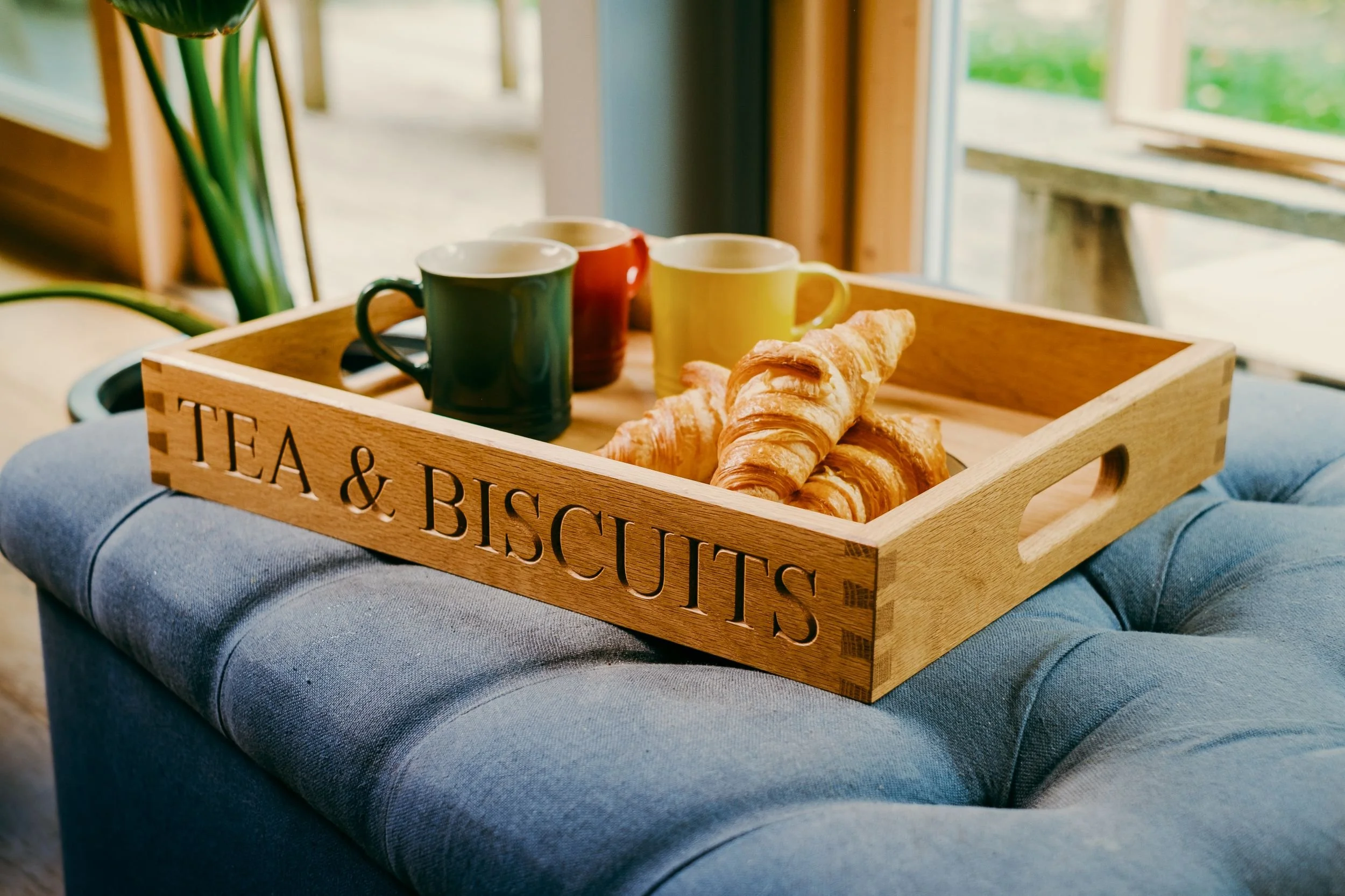 Solid oak butler tray with 'Tea & biscuits' engraved onto one side and dovetail joinery.