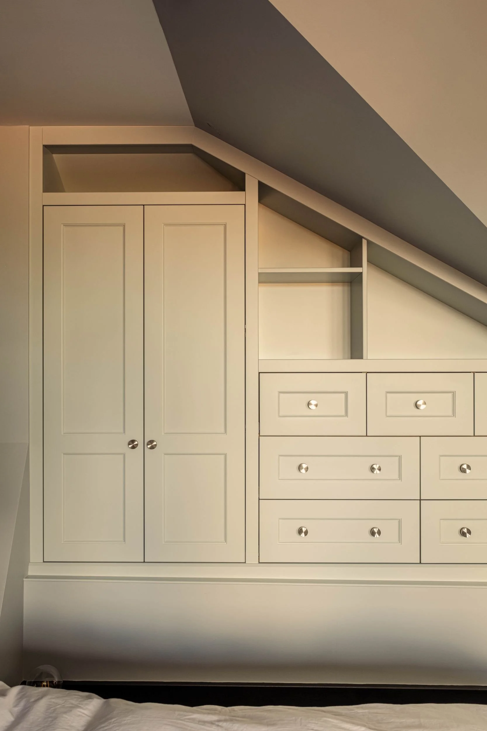 A made to measure wardrobe with open shelving and external drawers. The wardrobe doors and drawer fronts are all in a Shaker style design.