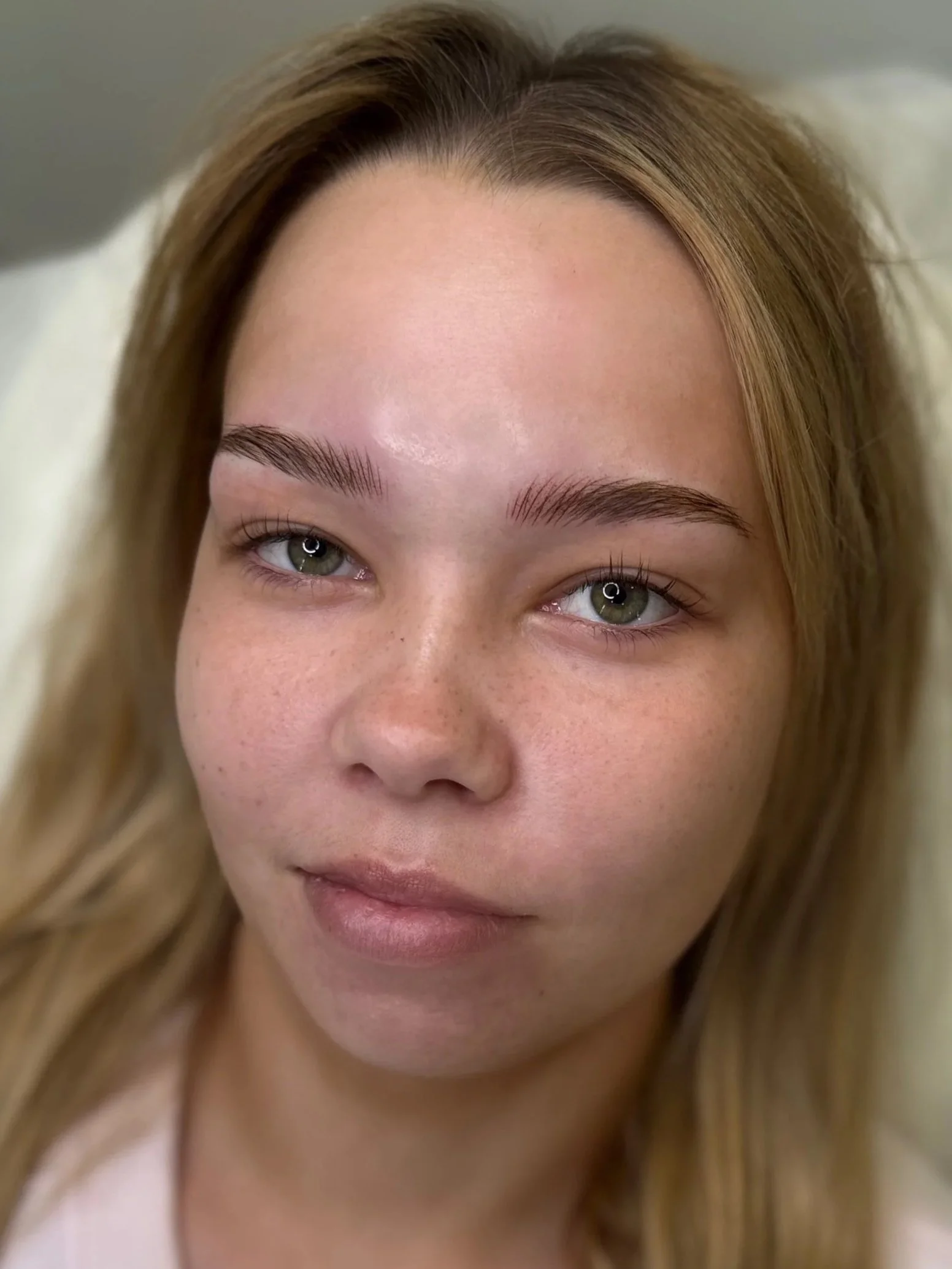 blonde girl with natural-looking fluffy eyebrow tattoo
