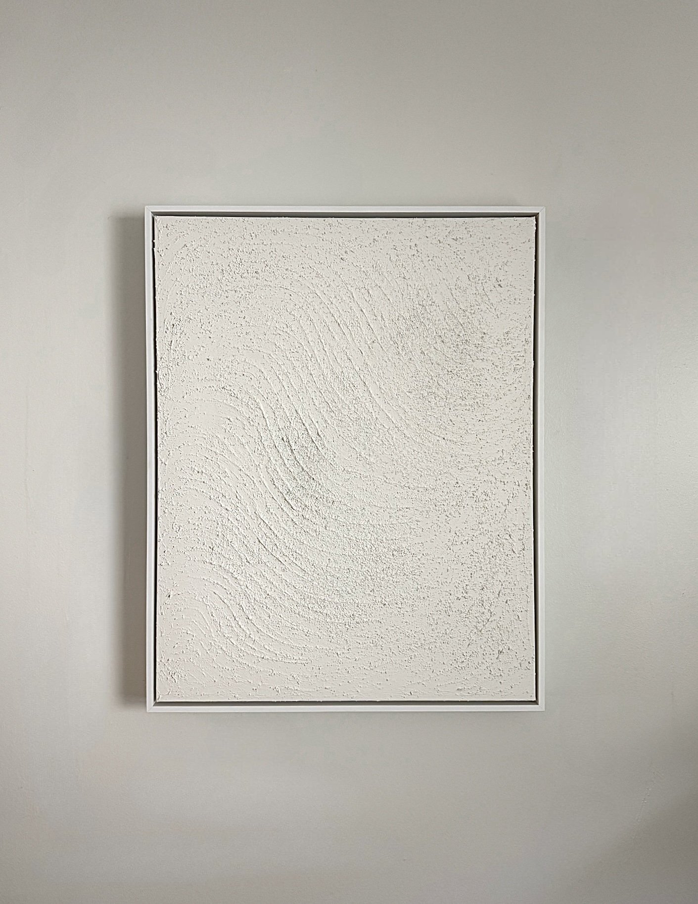 A light colored framed mixed media artwork on canvas.