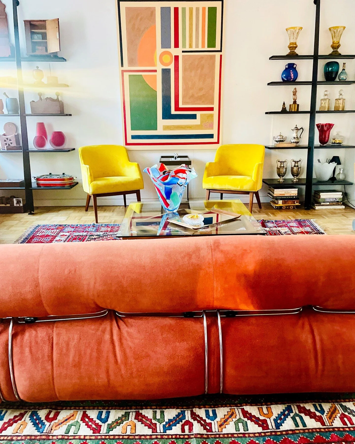 Our showroom is coming together! Vintage 1970's Soriana by Cassina in burnt orange in stunning suede fabric paired here with a pair of 1950's Jens Risom chairs. We love our Philippw Starck Mac Gee bookshelves showcasing some of our Murano collection 