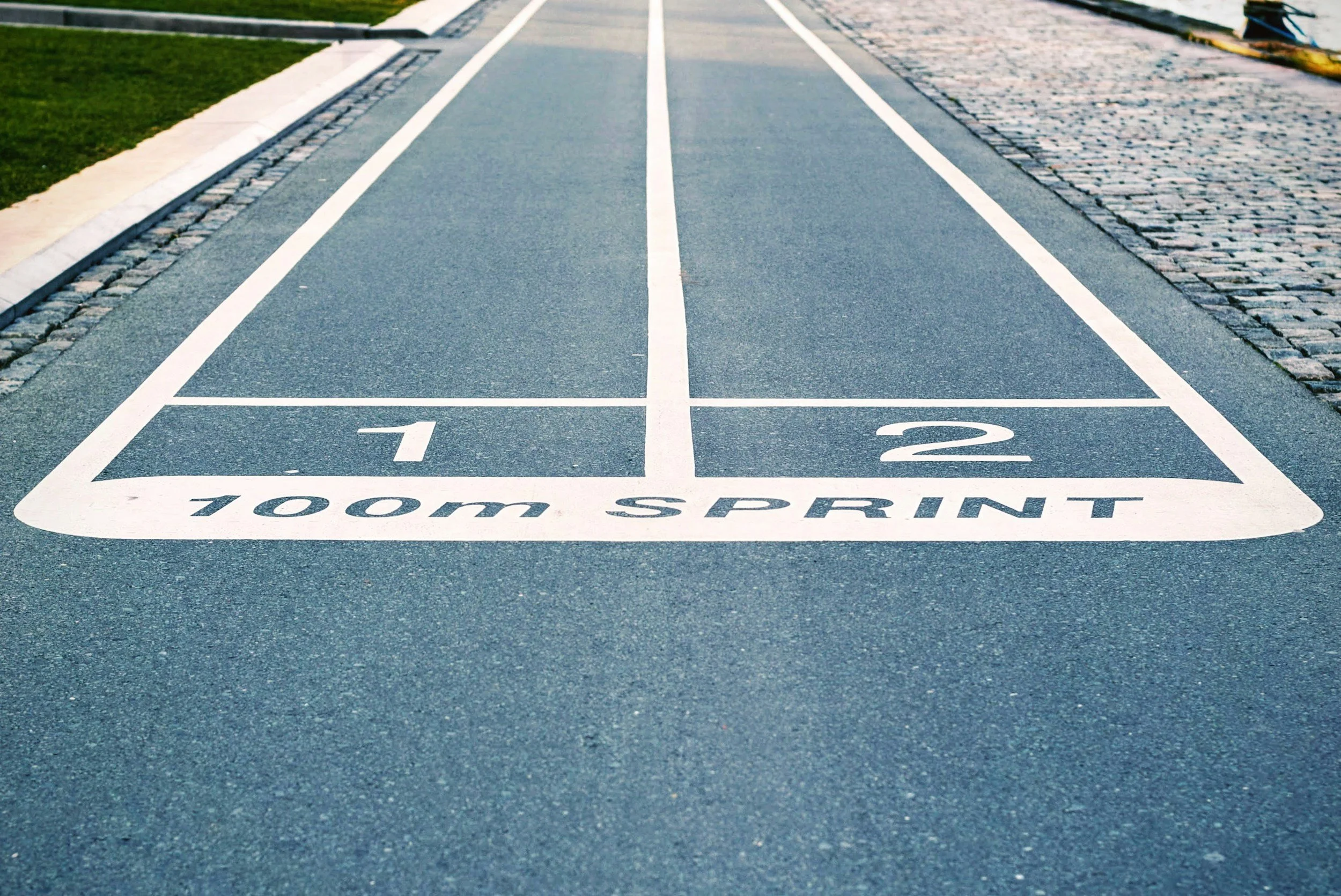 A shuffleboard court labeled '100m sprint' with marked lanes numbered 1 and 2.